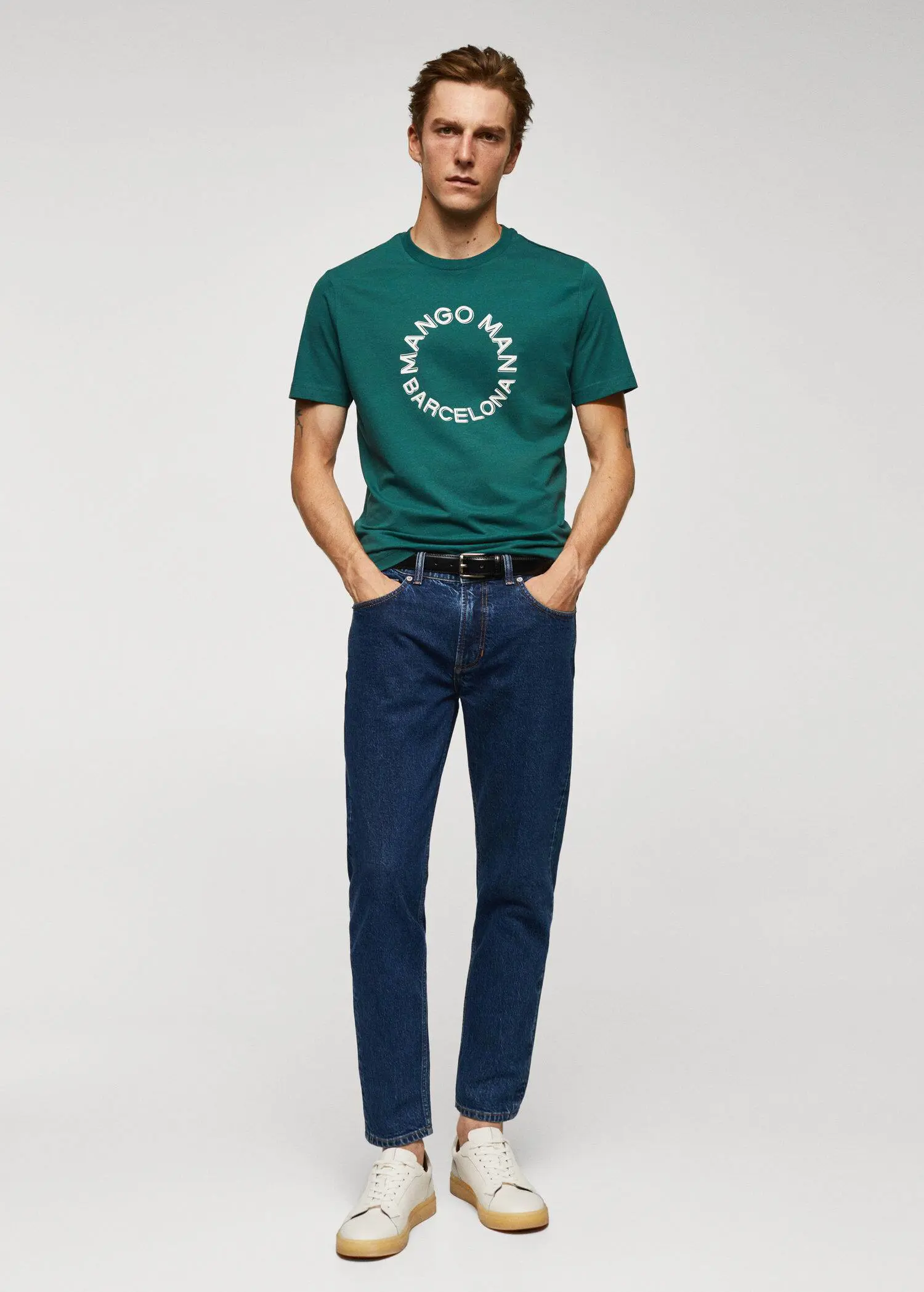Mango 100% cotton t-shirt with logo. a man in a green t-shirt and blue jeans. 