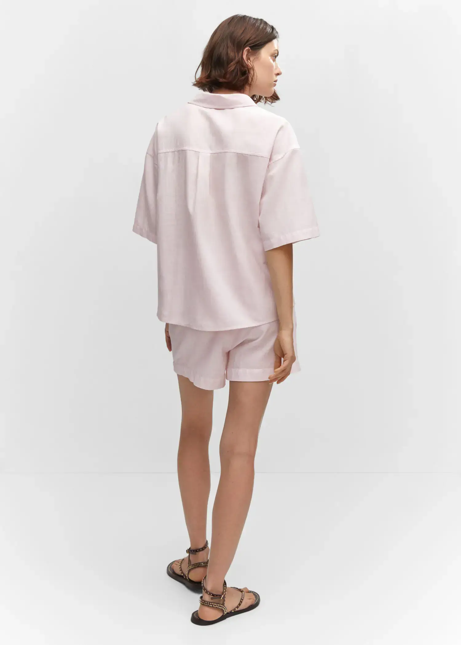 Mango Cotton linen-blend shirt. a person wearing a pink shirt and shorts. 