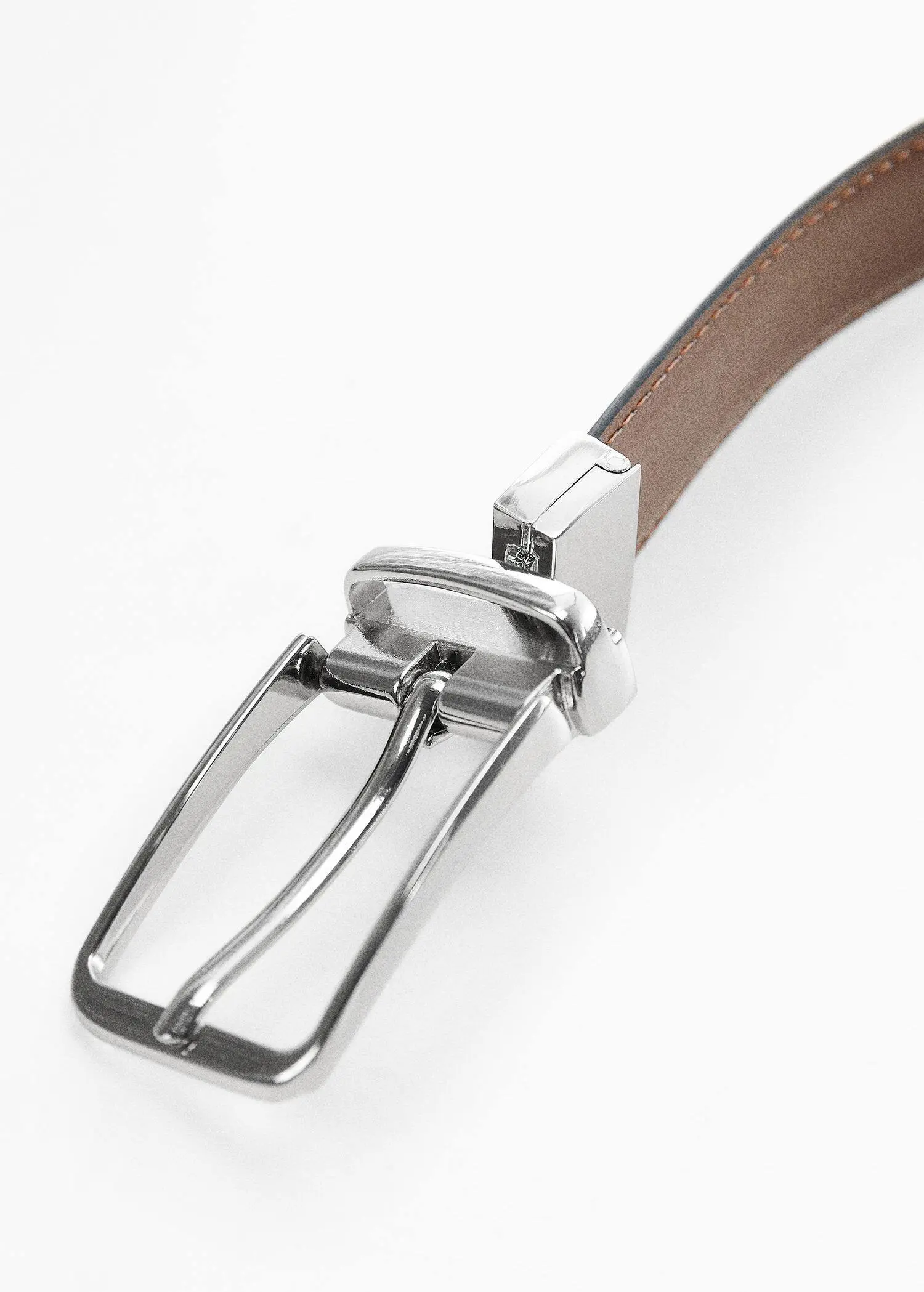 Mango Leather reversible belt. a close-up of a belt buckle on a brown belt. 