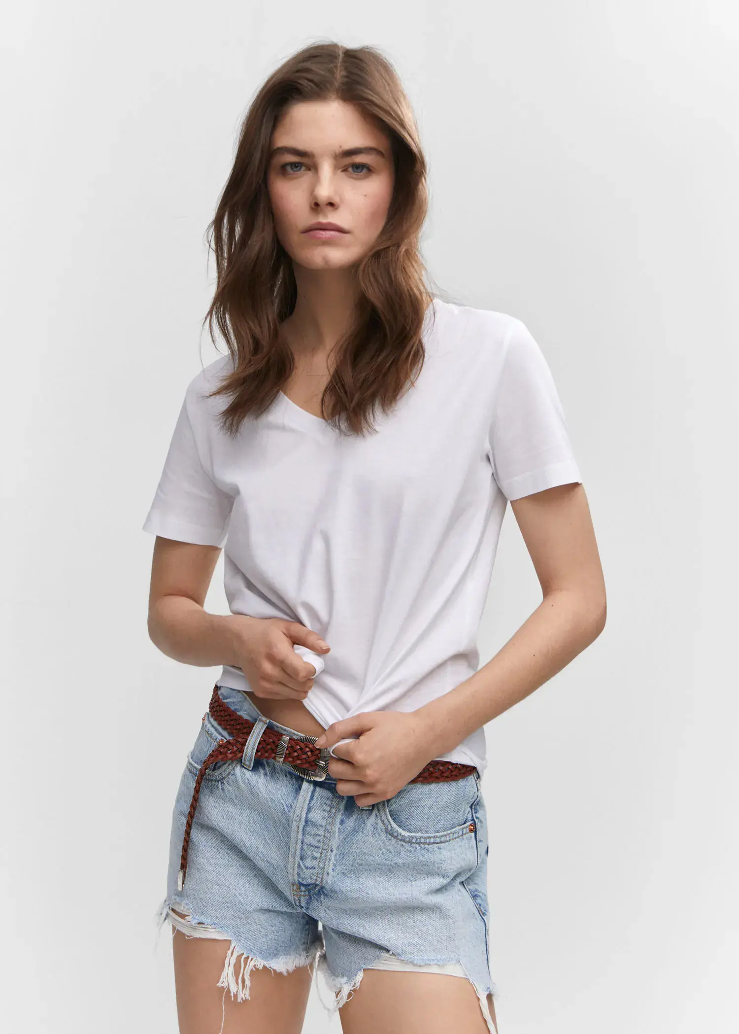 Mango V-neck cotton T-shirt. a woman in a white shirt and jeans. 