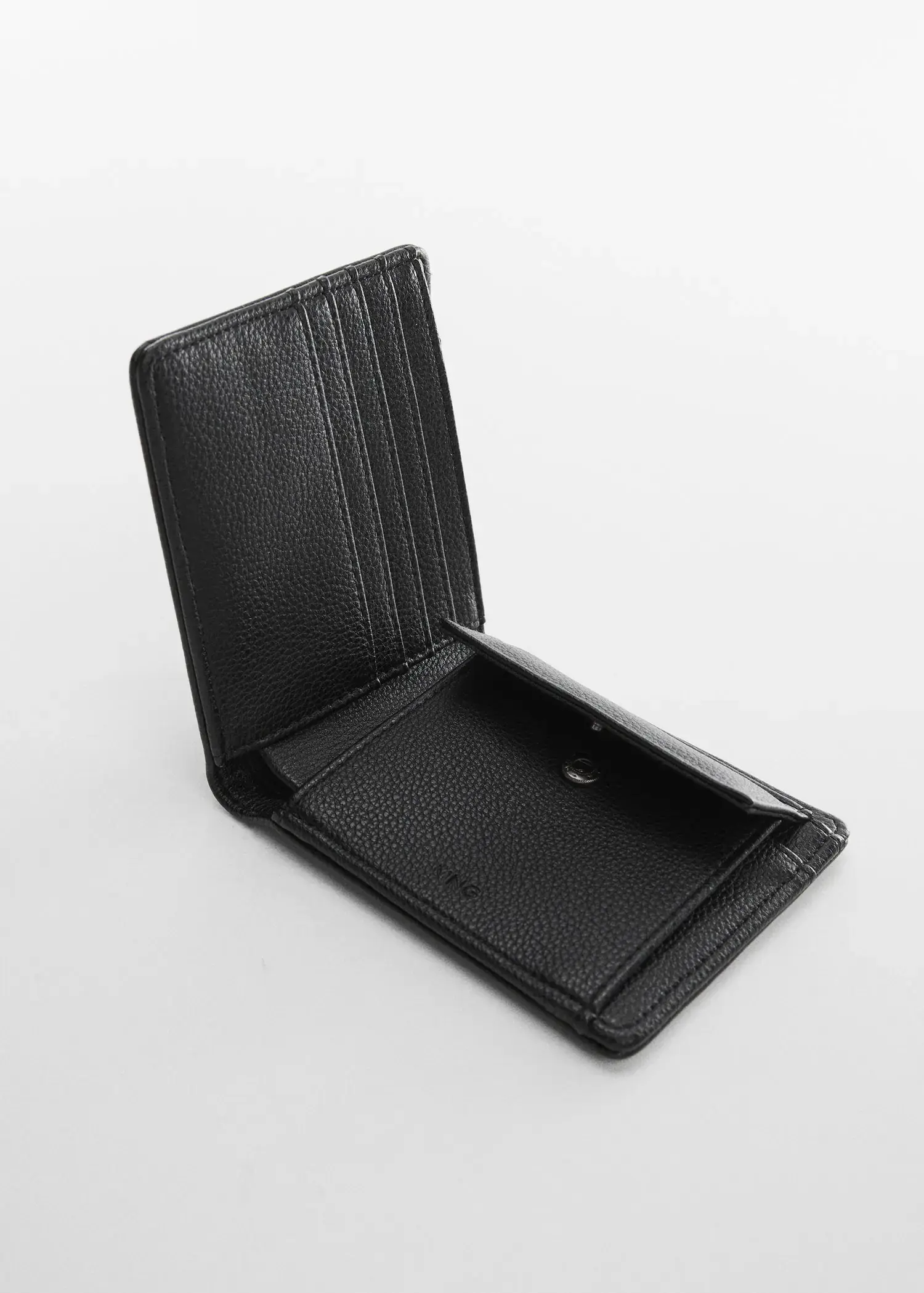 Mango Anti-contactless wallet. an open black wallet sitting on top of a white table. 
