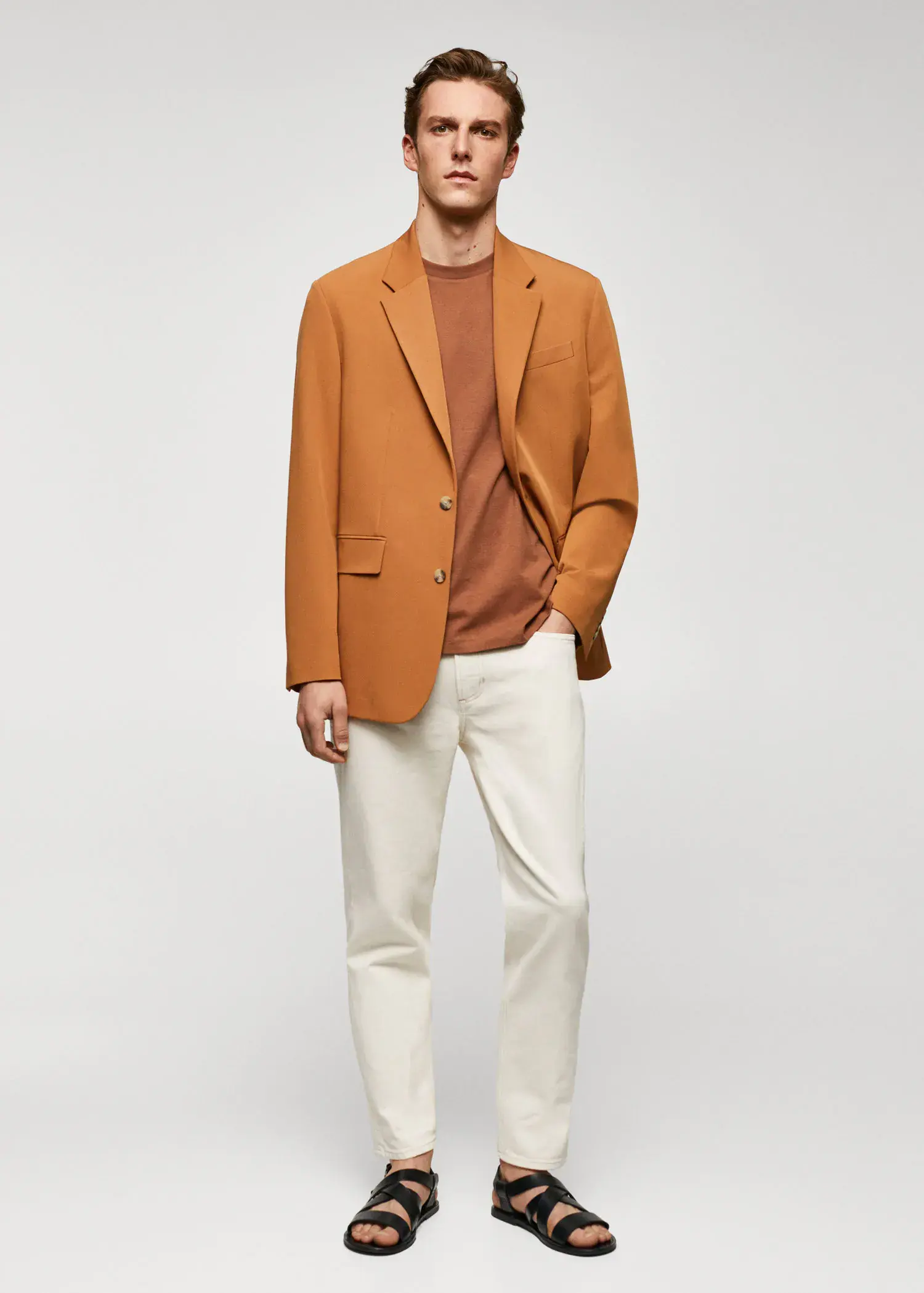 Mango Basic cotton stretch T-shirt. a man in a brown jacket and white pants. 