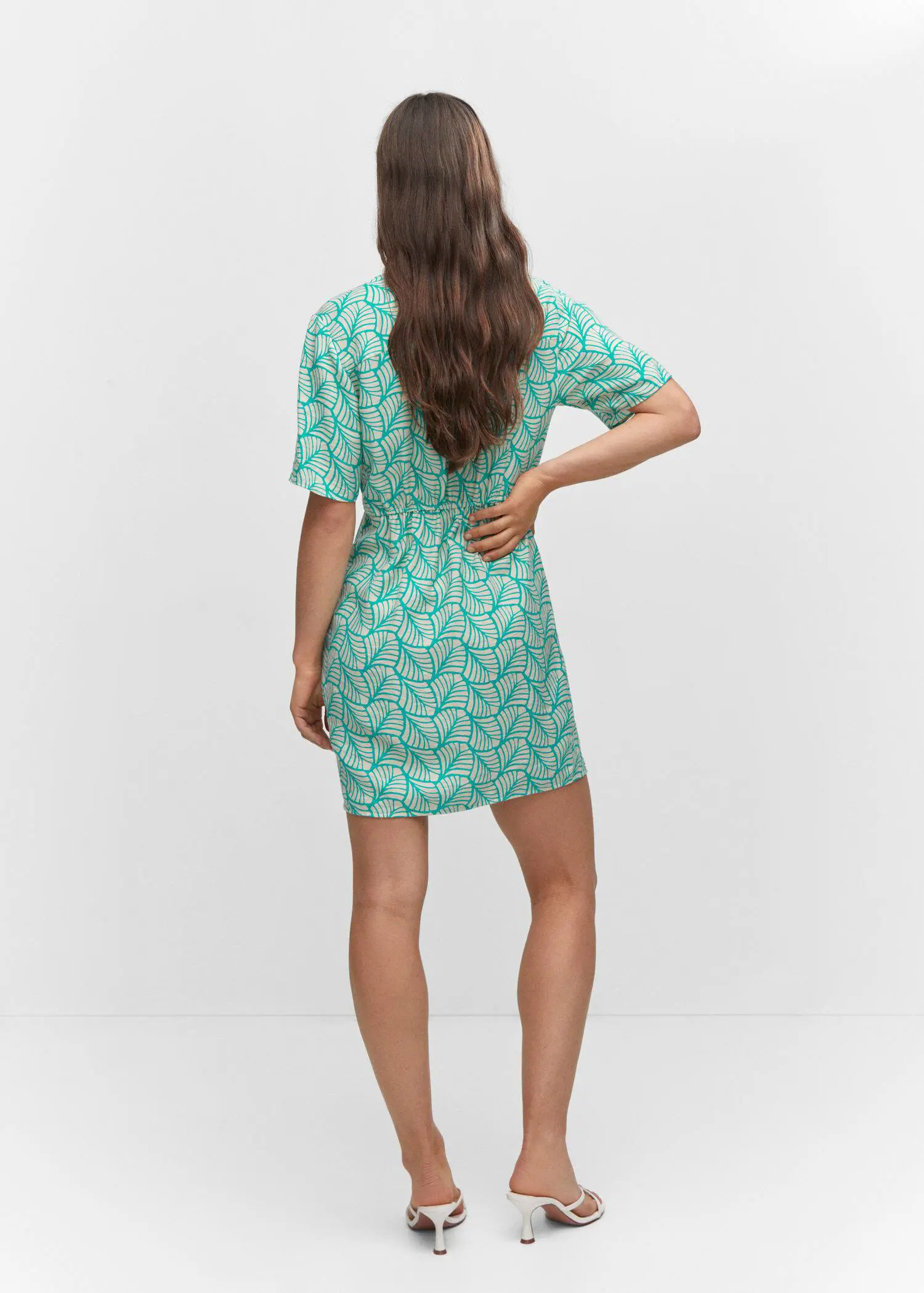 Mango Short printed wrap dress. a woman in a green and white dress. 
