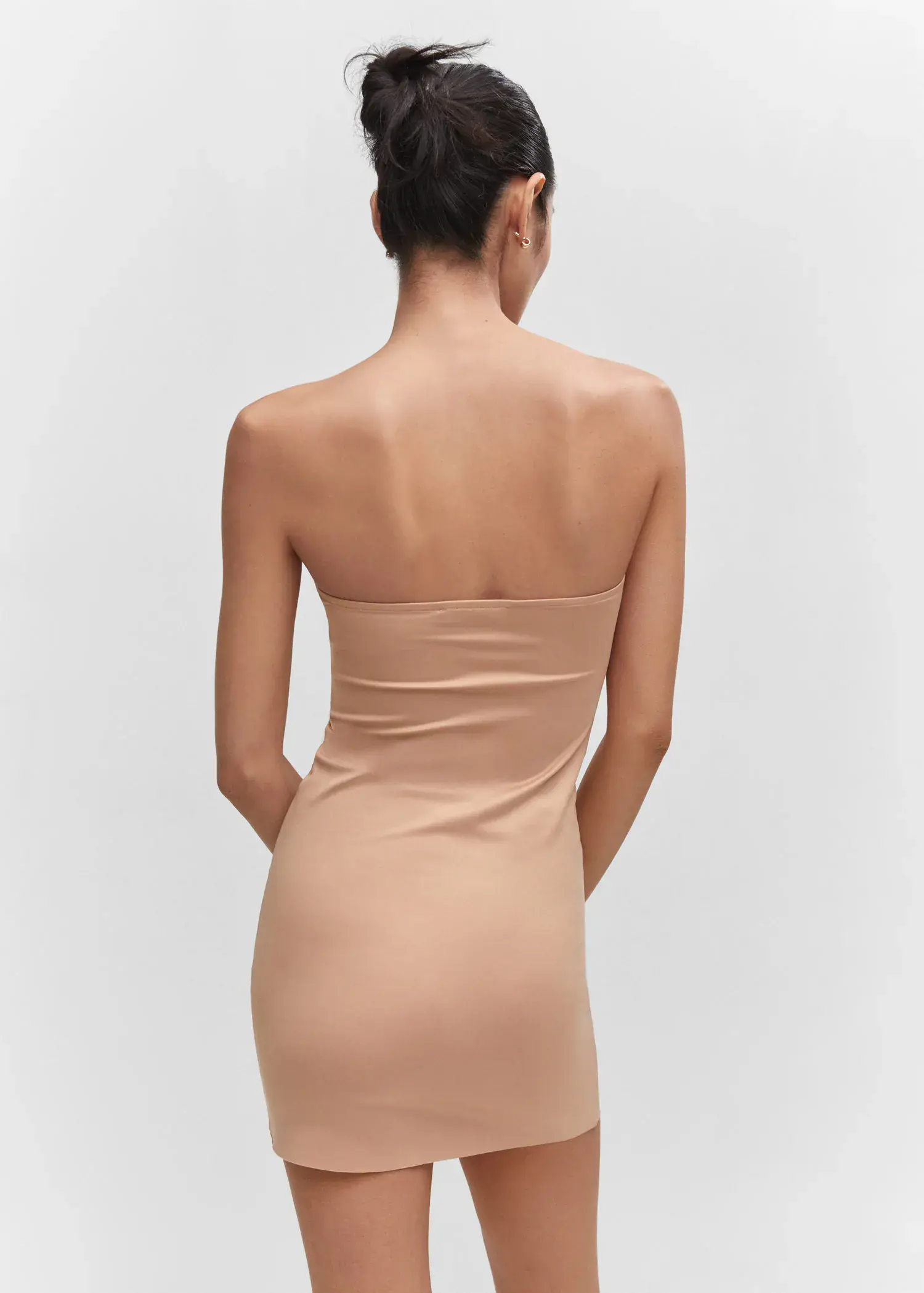Mango Seamless strapless dress. a woman in a tan dress standing in front of a white wall. 