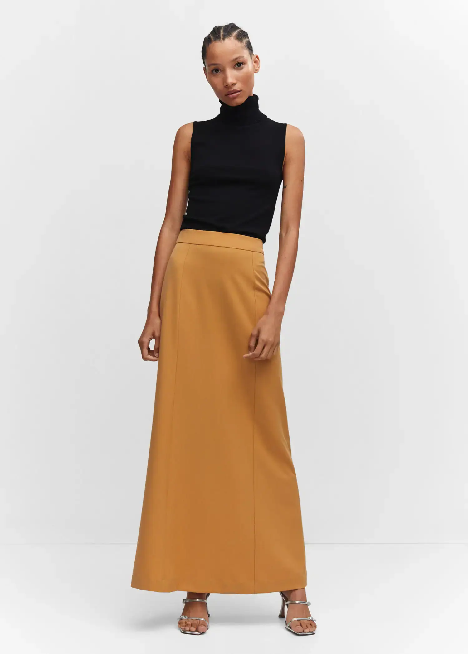 Mango Flowy long skirt. a woman wearing a black top and a long skirt. 