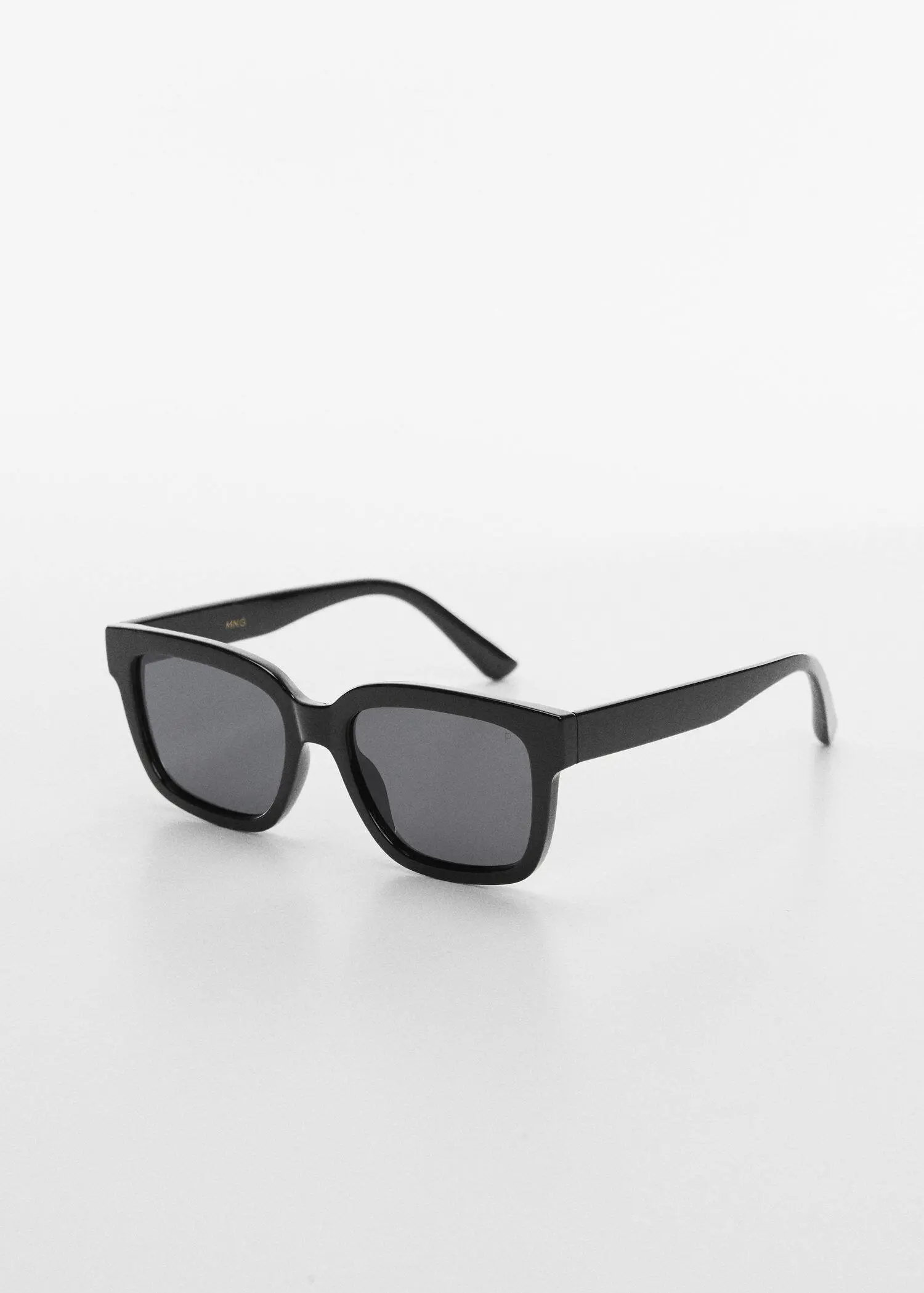 Mango Polarised sunglasses. a pair of sunglasses on a white surface. 