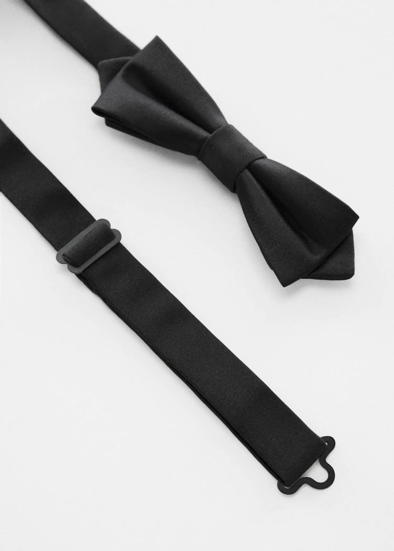 Mango Classic bow tie . a pair of black bow ties sitting next to each other. 