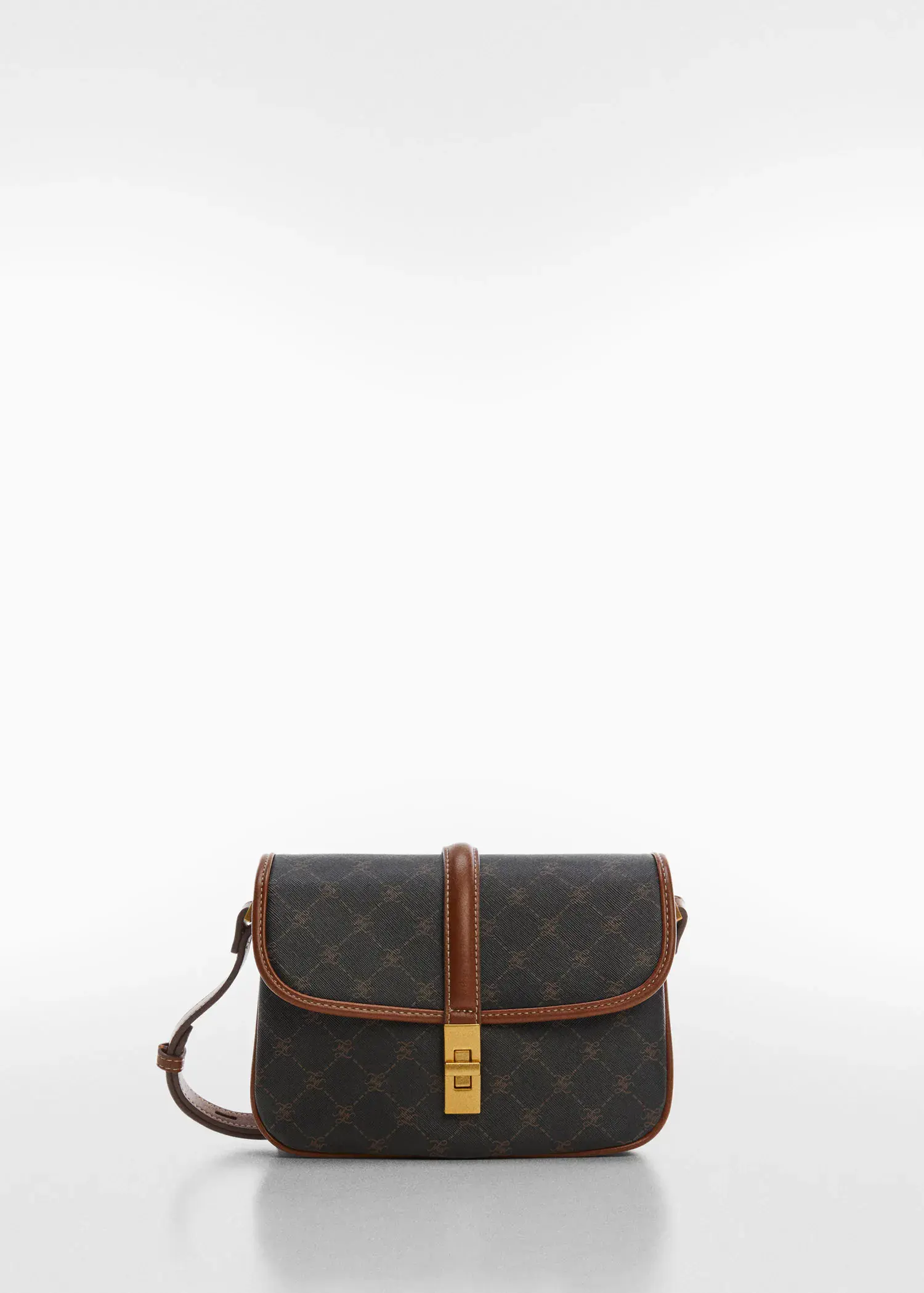 Mango Shoulder bag with printed logo. a brown and black bag is sitting on the ground 