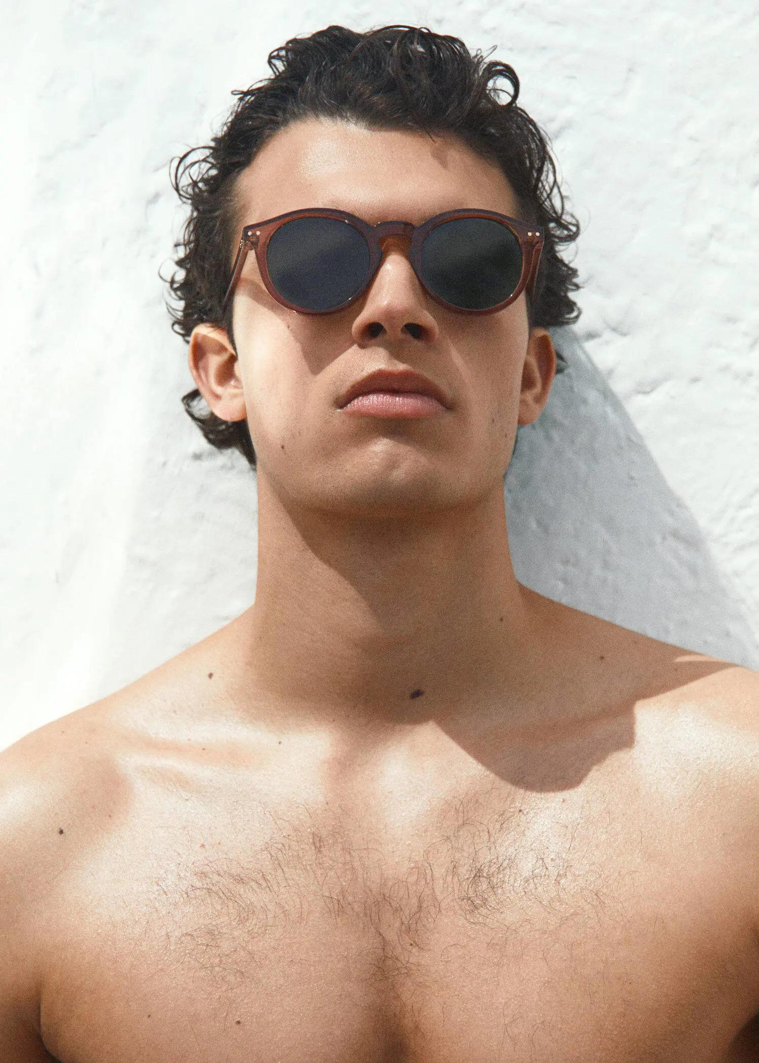 Mango Rounded sunglasses. a shirtless man with sunglasses on his face. 