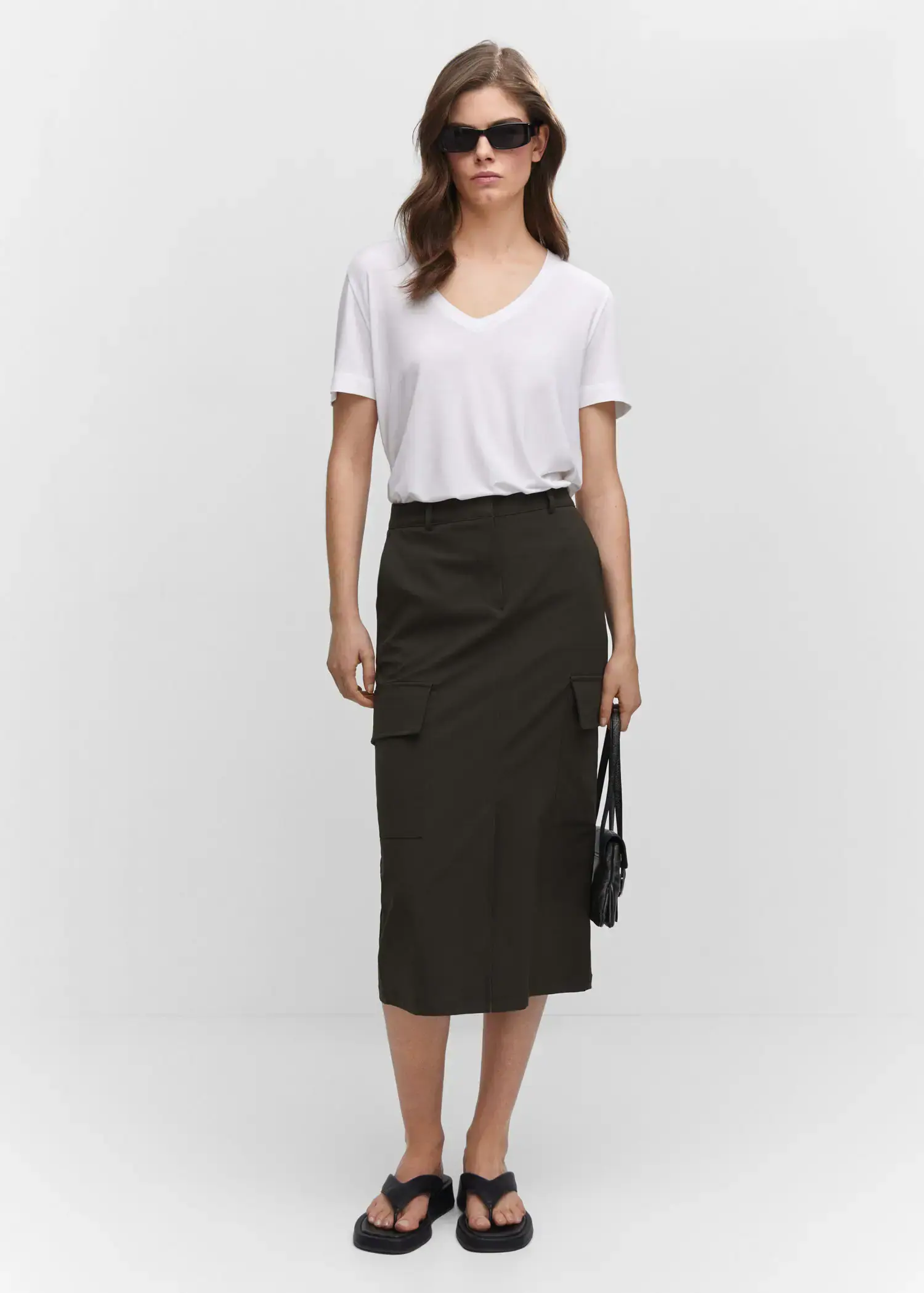 Mango V-neck T-shirt. a woman wearing a white shirt and a black skirt. 