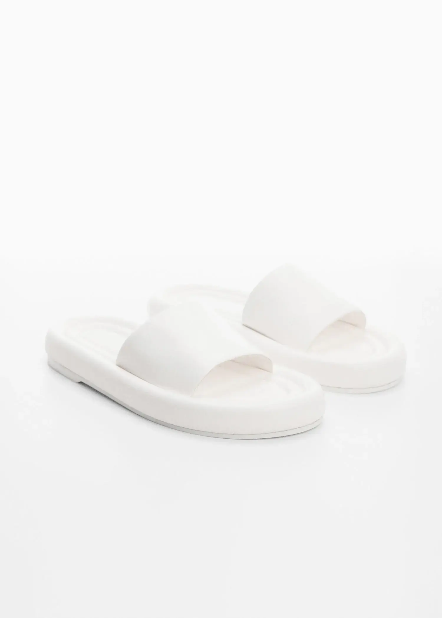 Mango Leather thong sandals. a pair of white sandals sitting on top of a white surface. 