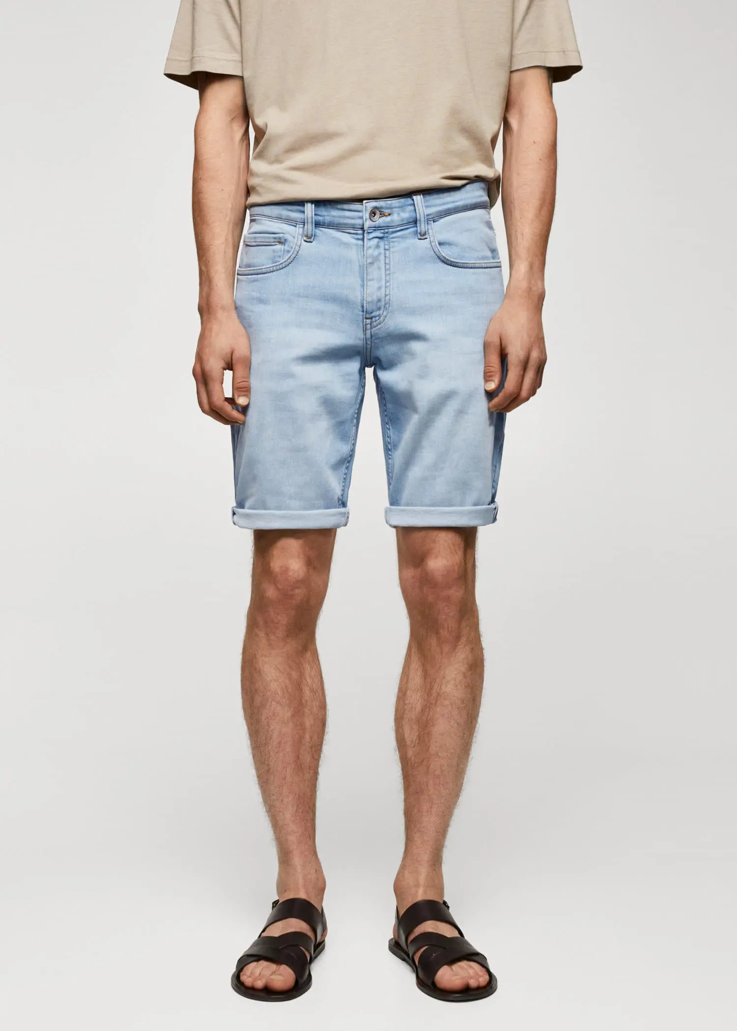 Mango Slim-fit denim bermuda shorts. a man wearing light blue shorts and a tan shirt. 