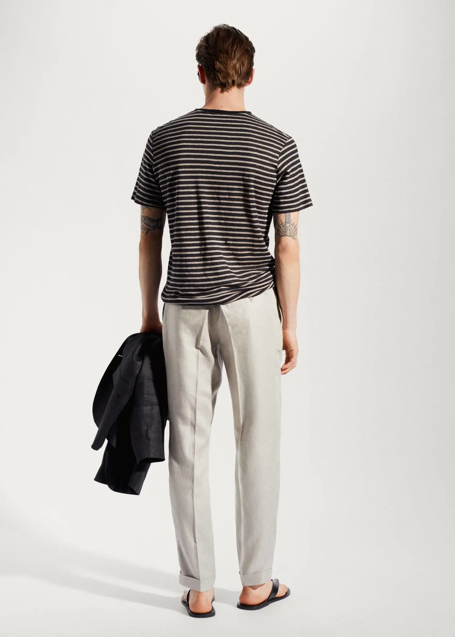 Mango 100% linen striped t-shirt. a man wearing a striped shirt and a jacket. 