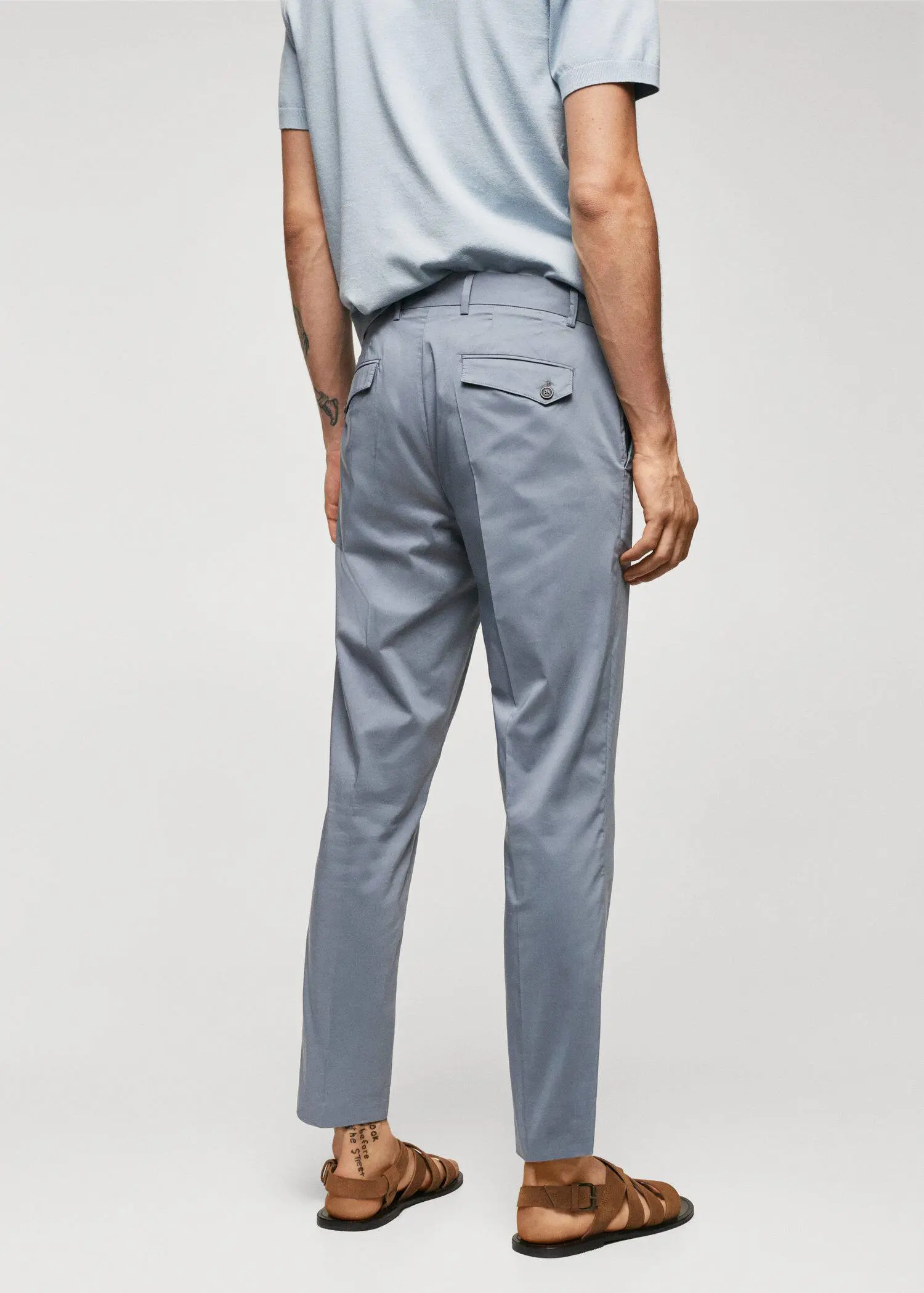 Mango Lightweight cotton trousers. a man wearing a blue shirt and gray pants. 