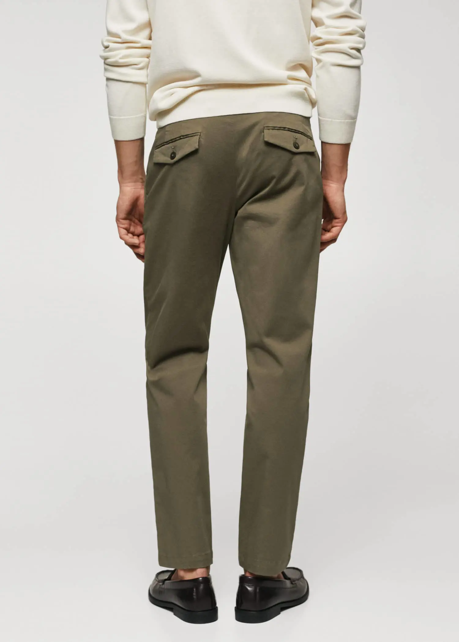 Mango Cotton tapered crop pants. a man wearing a sweater and a pair of pants. 