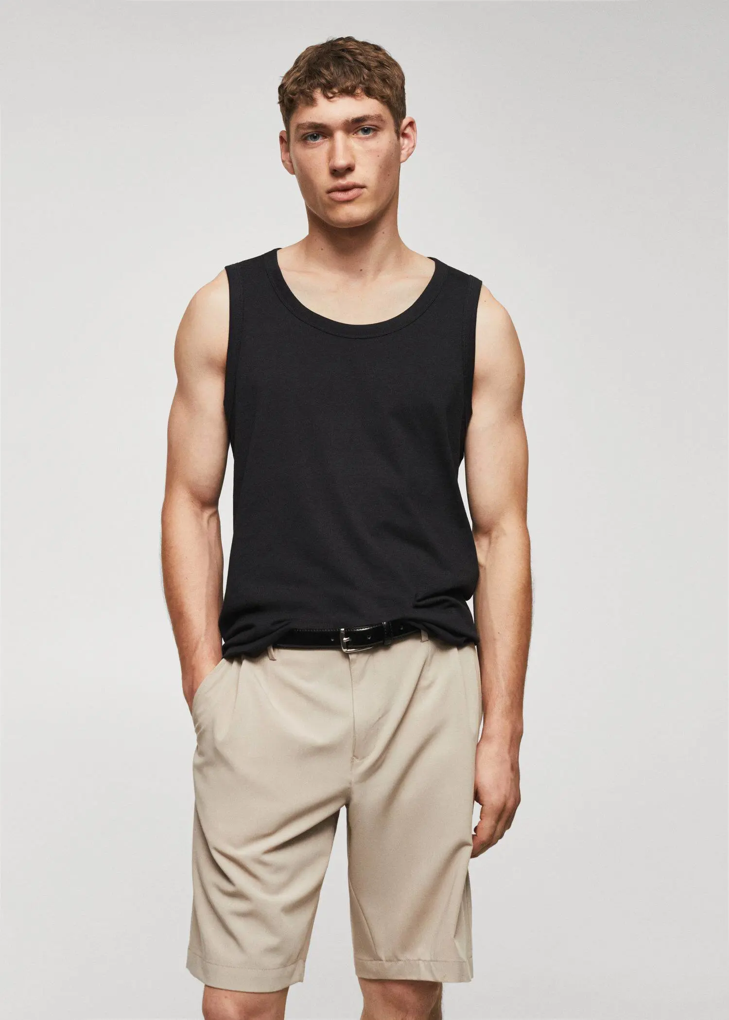 Mango Strap cotton T-shirt. a man wearing a black tank top and beige pants. 