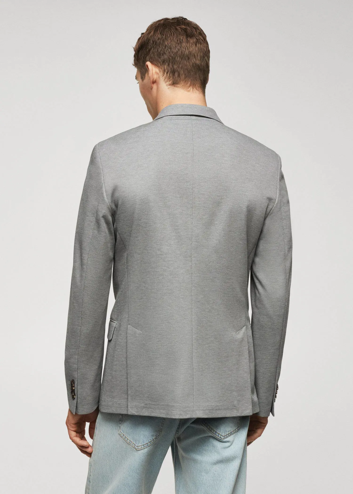 Mango Slim fit microstructure blazer. a man wearing a gray jacket and jeans. 