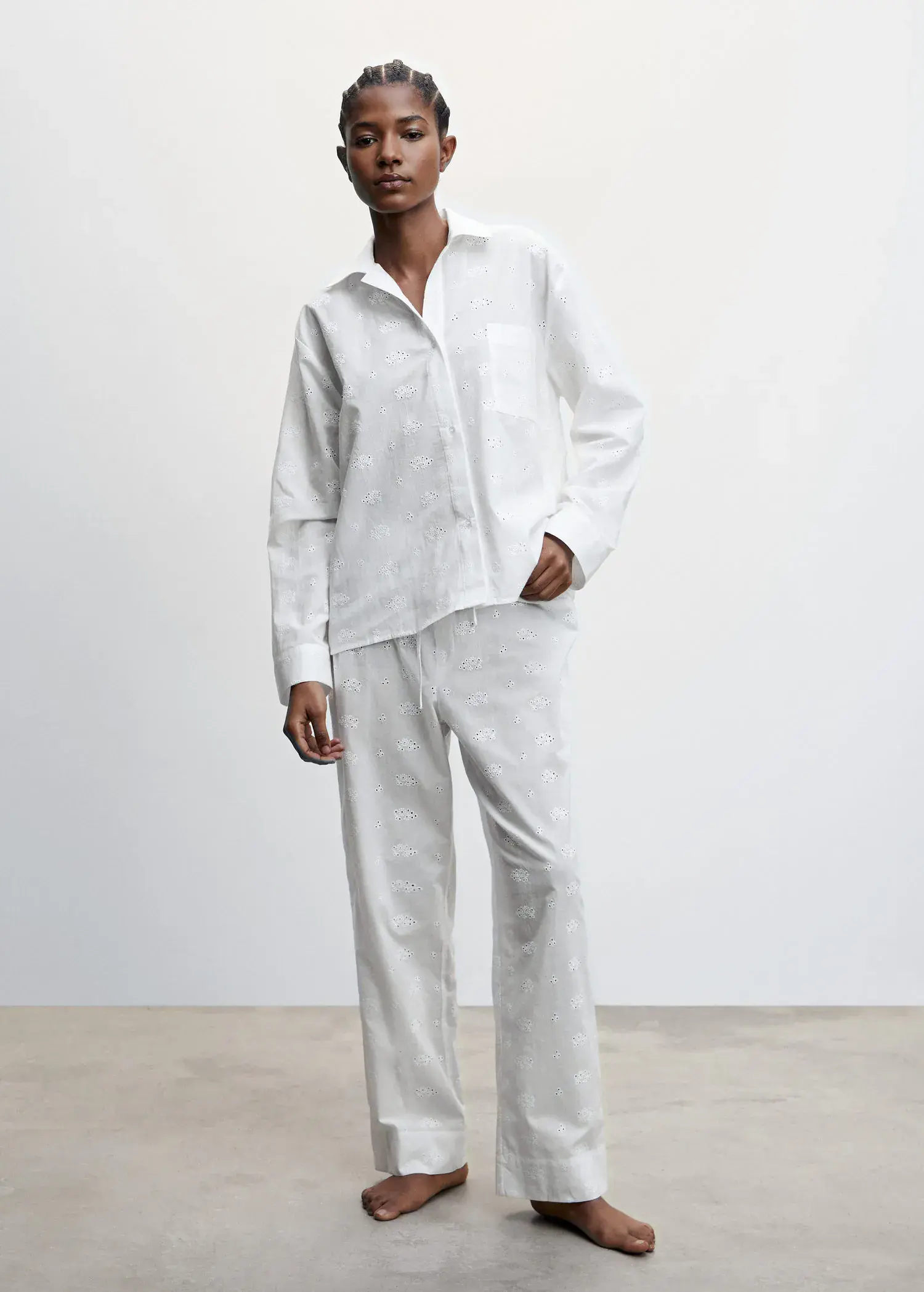 Mango Pajama shirt with openwork details. a man in white shirt and pants standing next to a wall. 