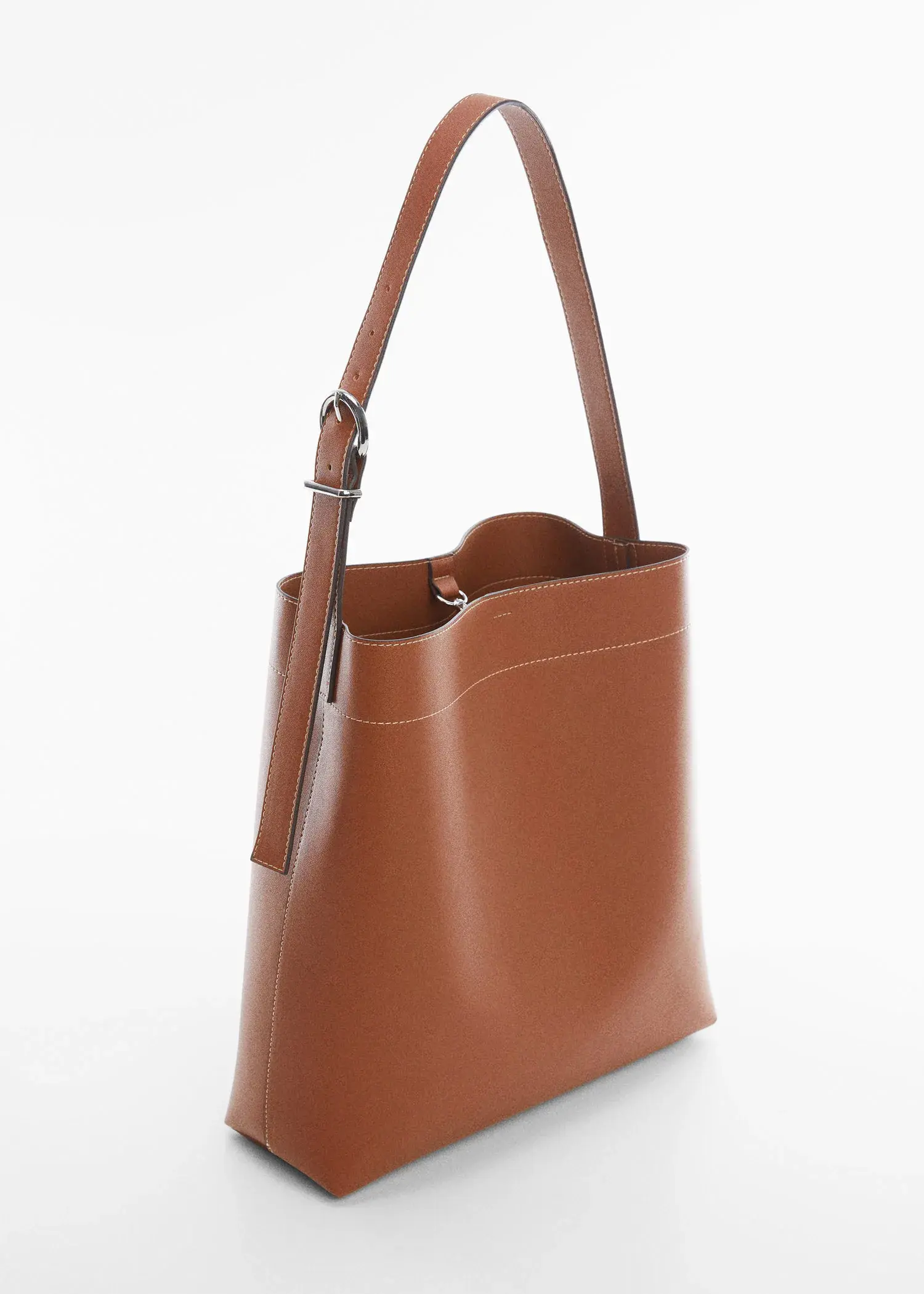 Mango Short handle shopper bag. a close-up of the side of a brown leather bag. 