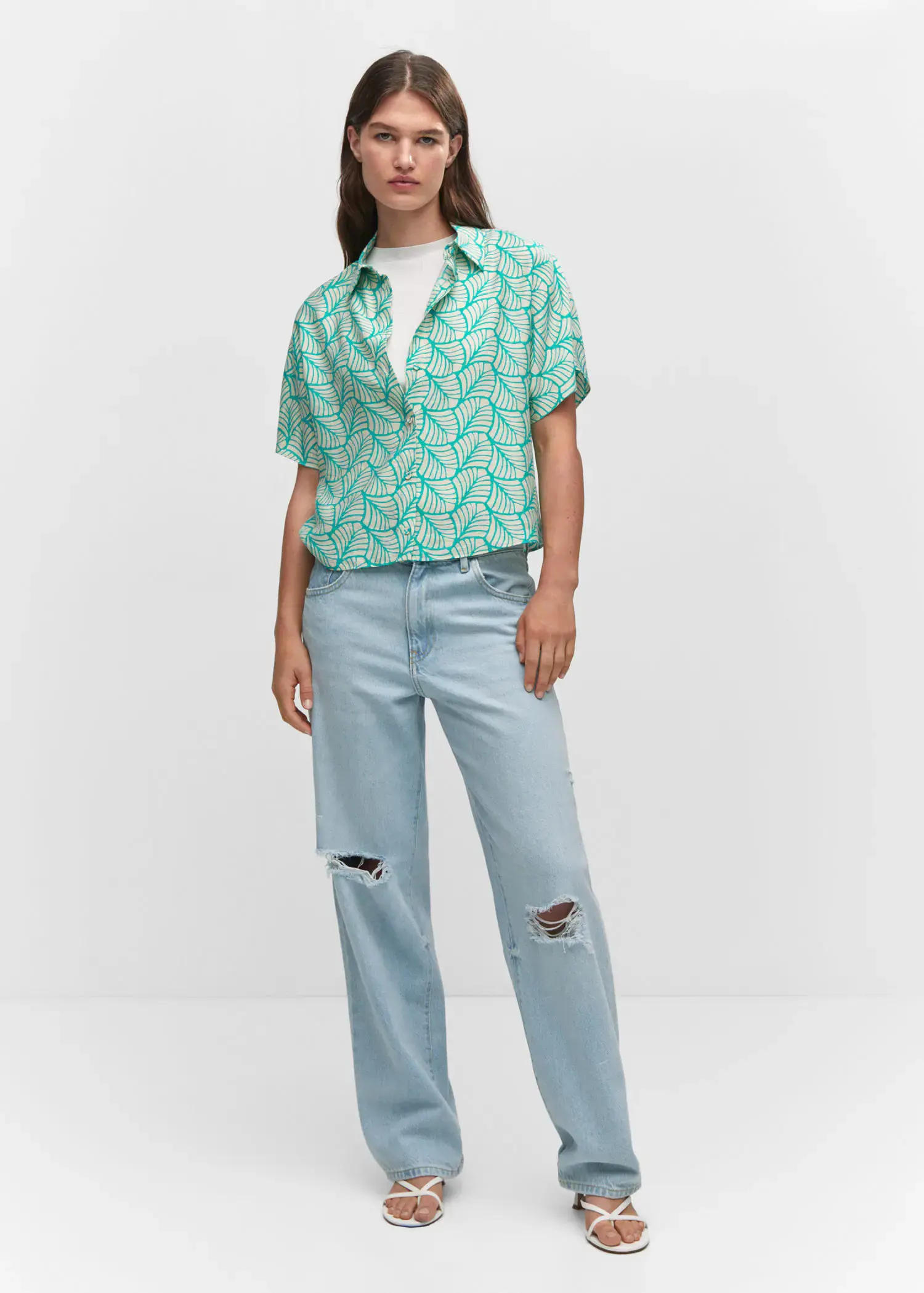 Mango Buttoned printed shirt. a woman in a green shirt and blue jeans. 