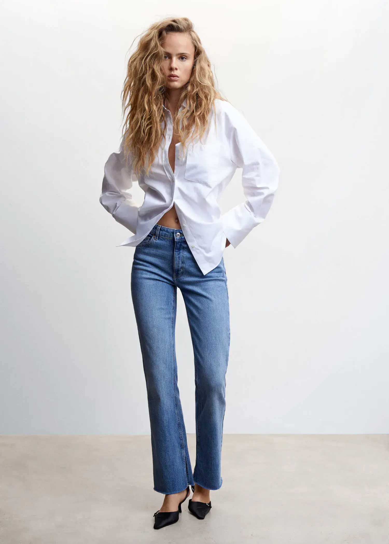 Mango Shirt with adjustable back . a woman in a white shirt and blue jeans. 