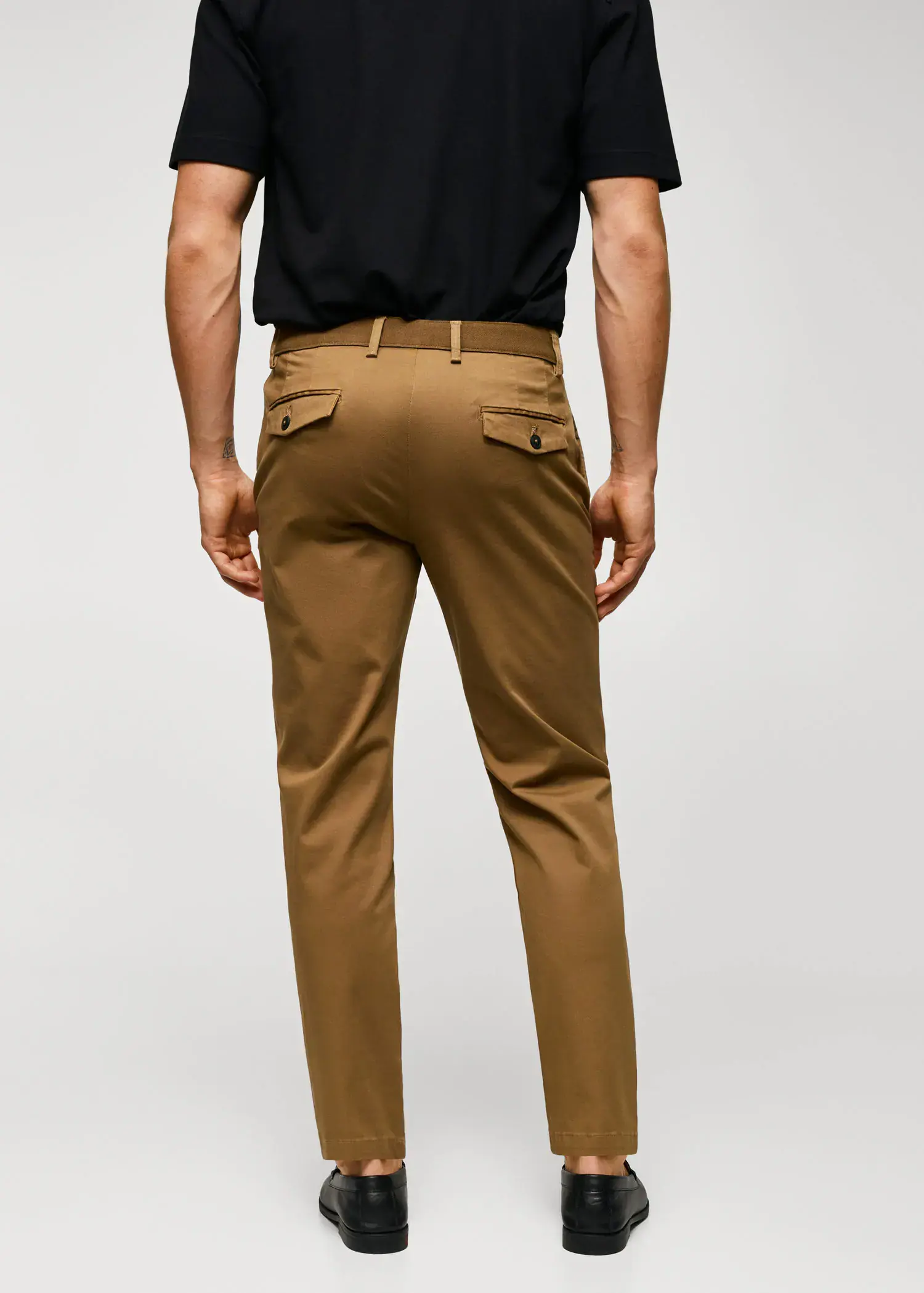 Mango Cotton tapered crop pants. a man wearing a black shirt and brown pants. 