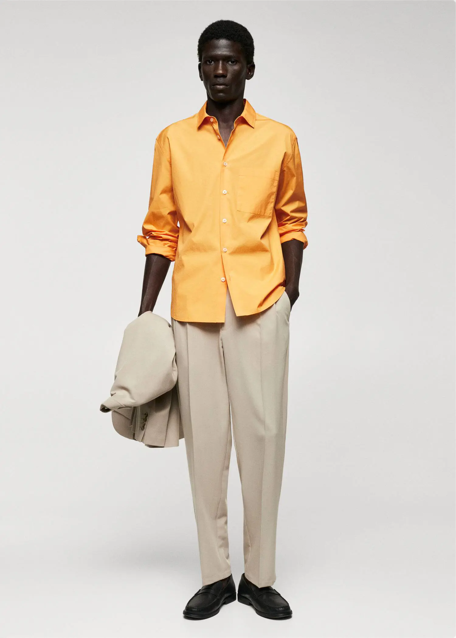 Mango 100% cotton pocket shirt. a man wearing a yellow shirt and beige pants. 