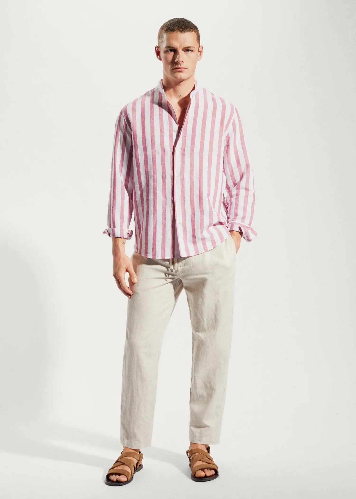 Mango Regular-fit striped linen shirt. a man wearing a pink and white striped shirt and white pants. 