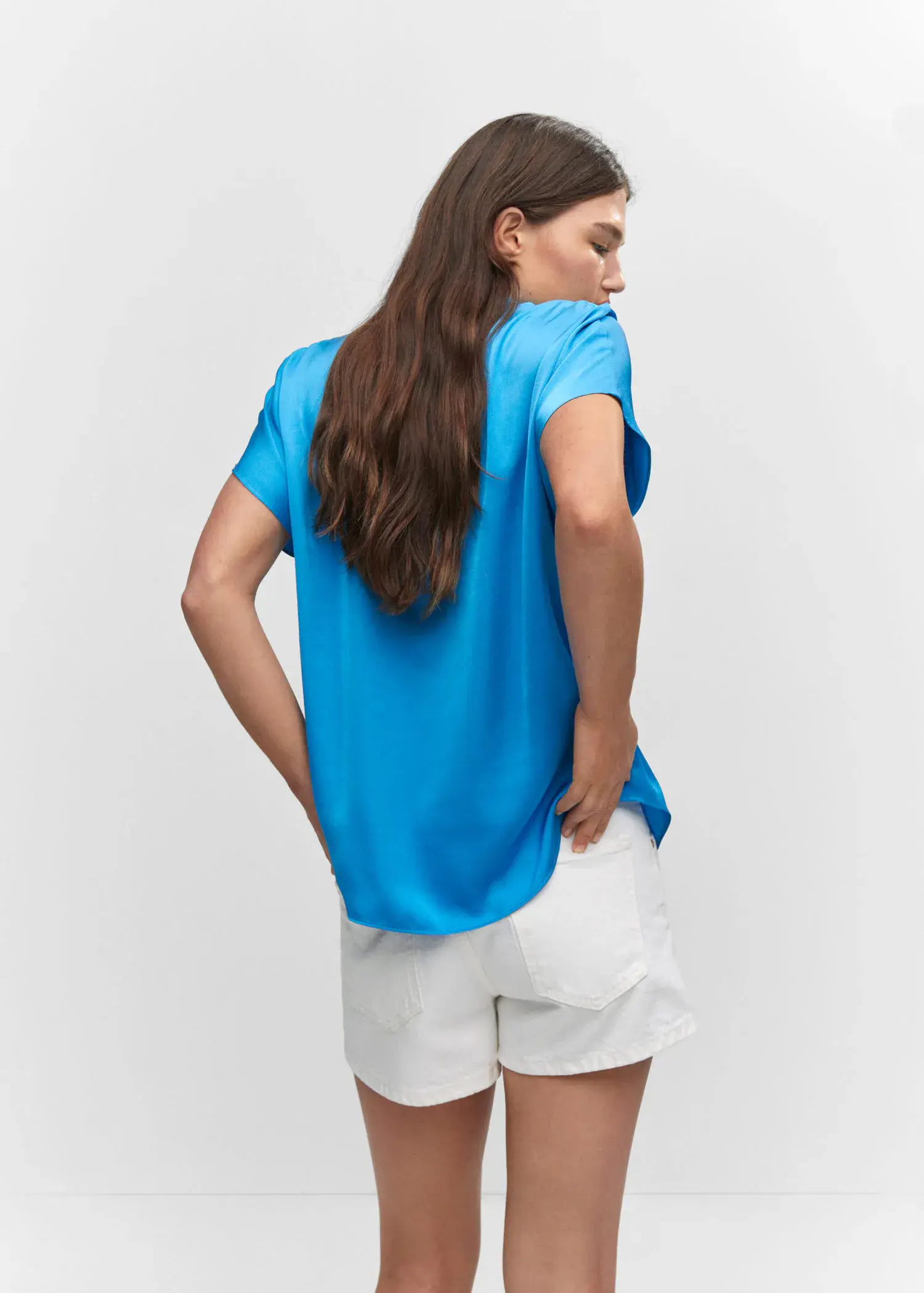 Mango Short-sleeve button-down shirt. a woman wearing a blue shirt and white shorts. 