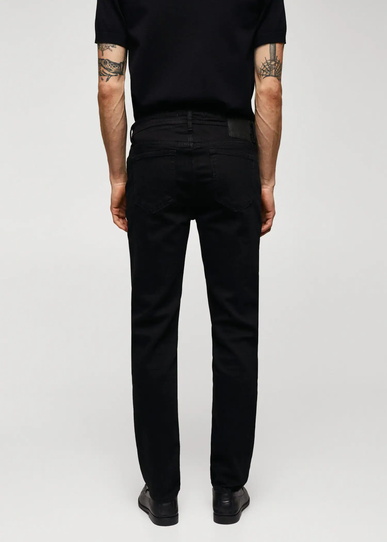 Mango Jan slim-fit jeans. a man wearing a black shirt and black pants. 