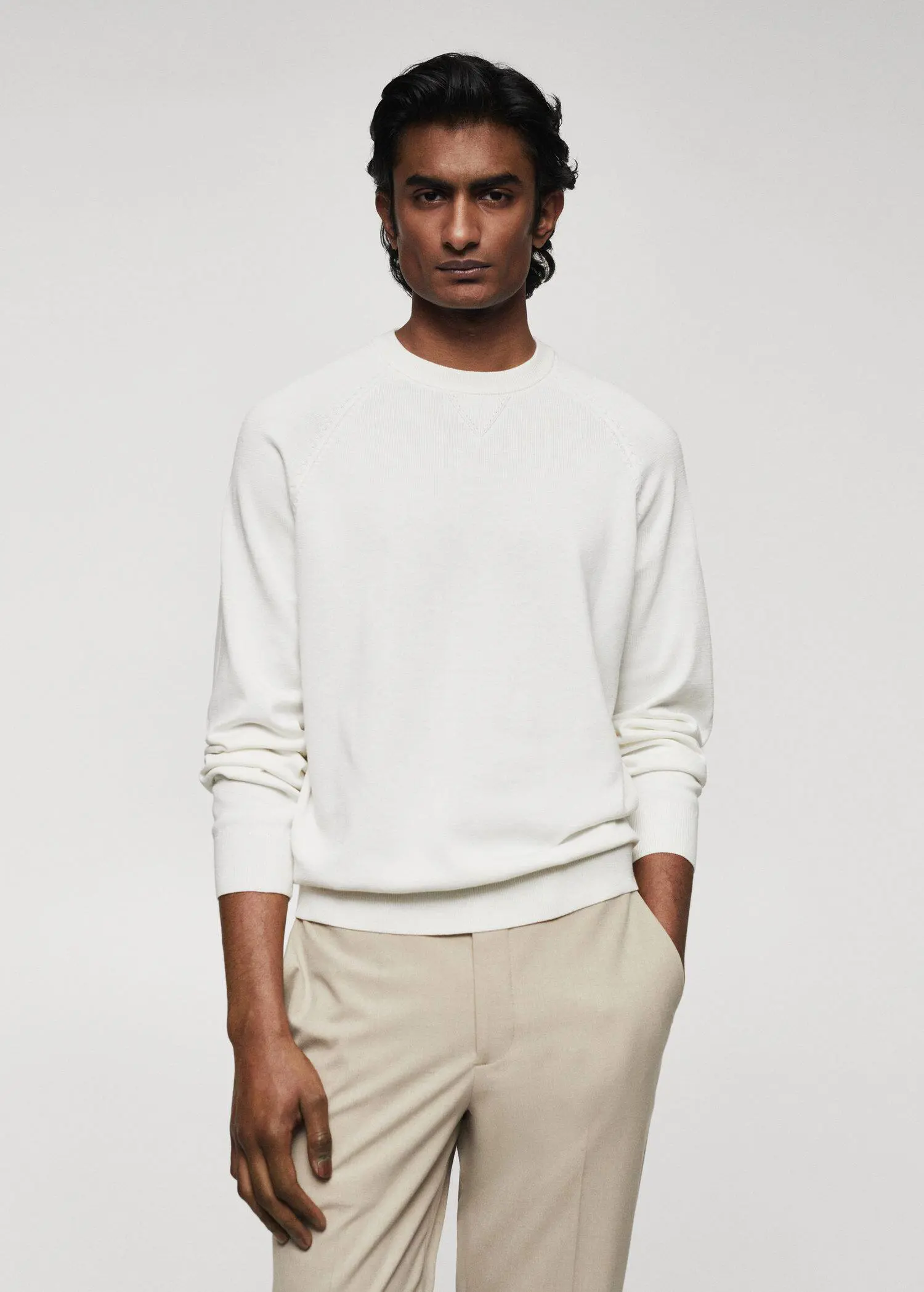 Mango Fine-knit cotton sweater. a man wearing a white sweater and beige pants. 
