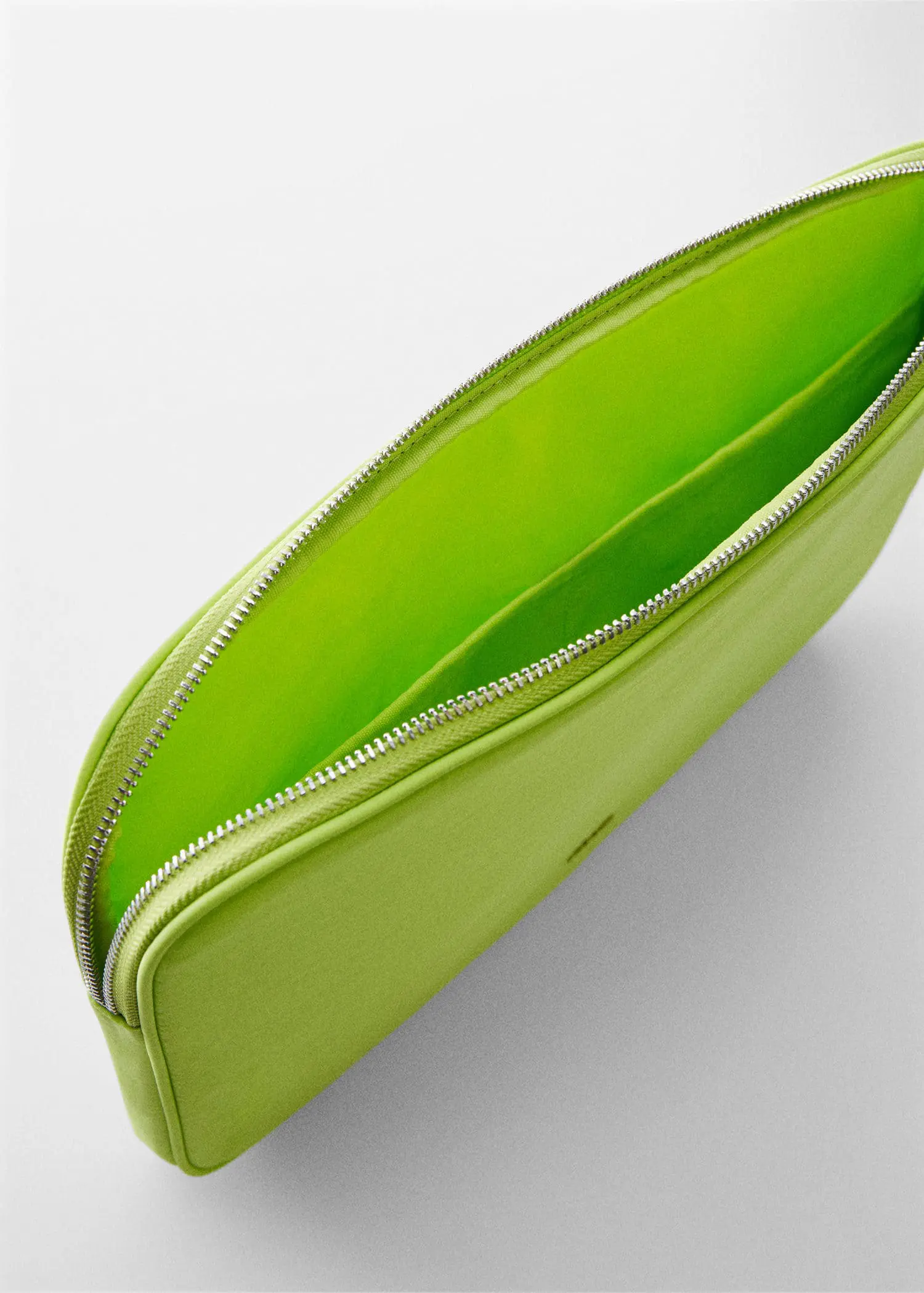 Mango Double-compartment laptop case. a close-up of the inside of a green purse. 