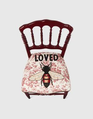 Wood chair with embroidered bee