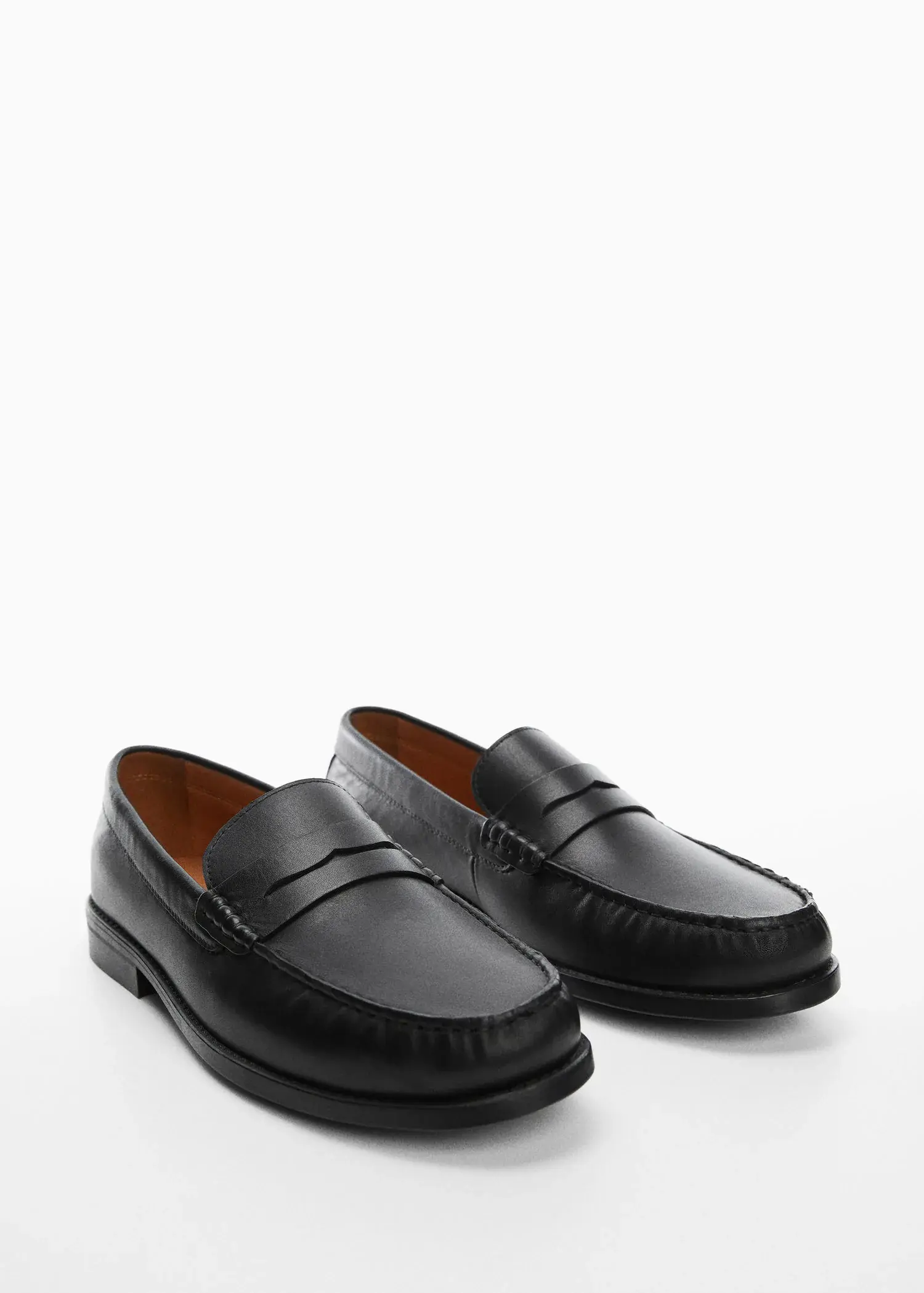 Mango Leather penny loafers. a pair of black loafers on top of a white surface. 