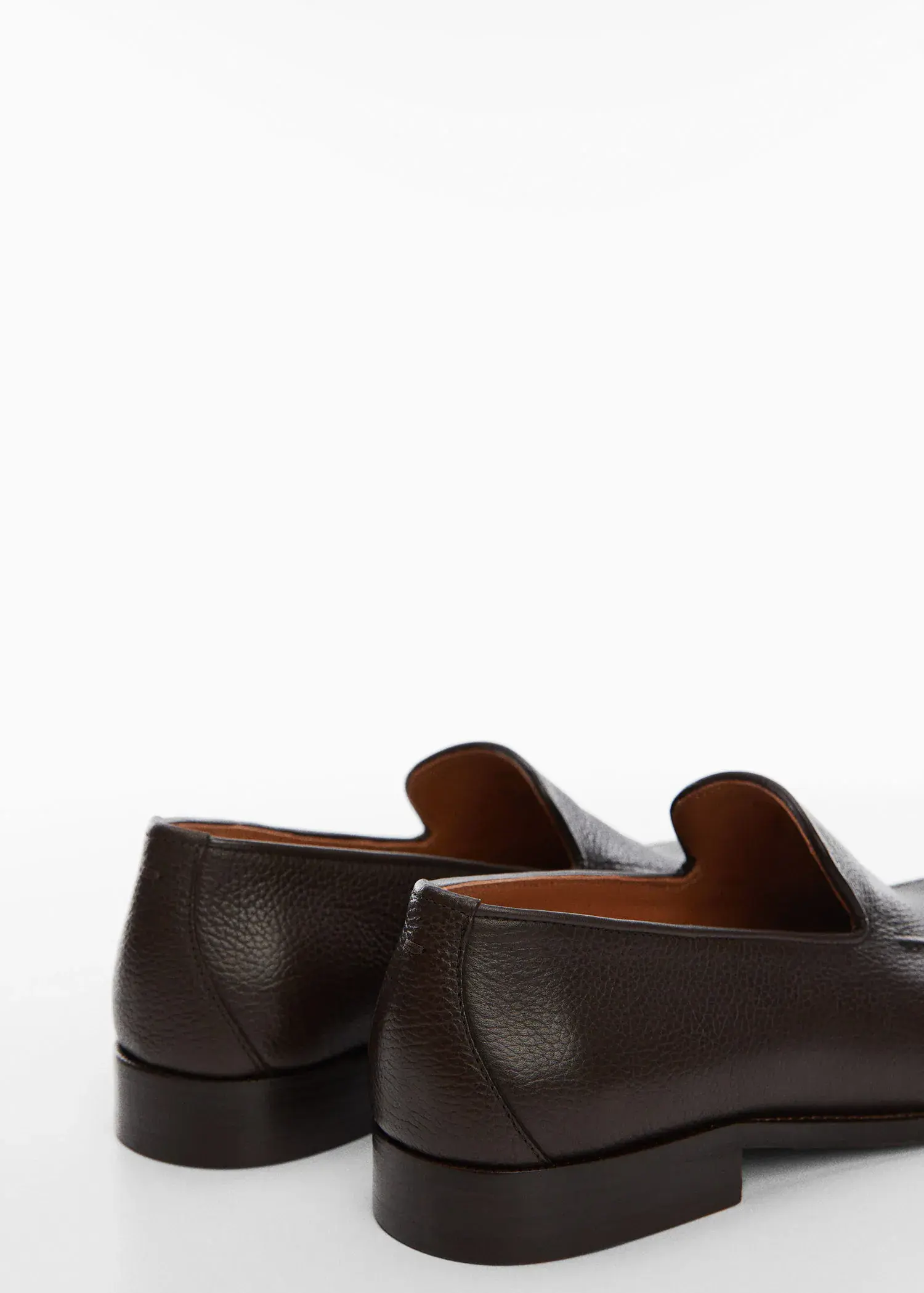 Mango Minimalist leather moccasins. a close up of a pair of brown shoes. 