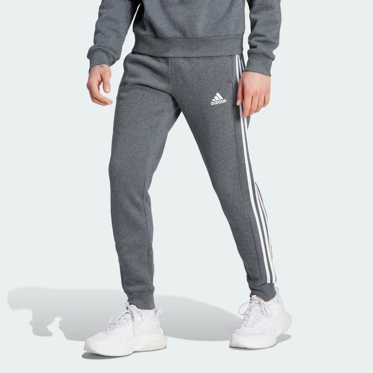 Adidas Essentials Fleece 3-Stripes Tapered Cuff Pants. 1