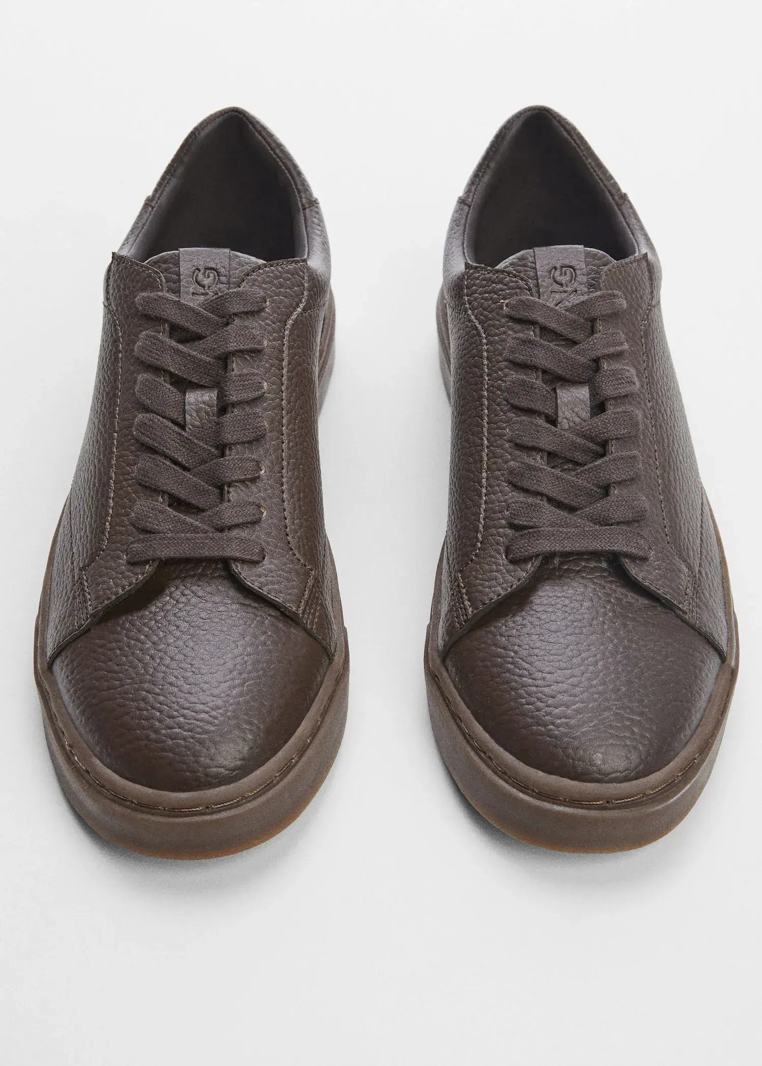 Mango Pebbled leather sneakers. a close up of a pair of shoes on a table 
