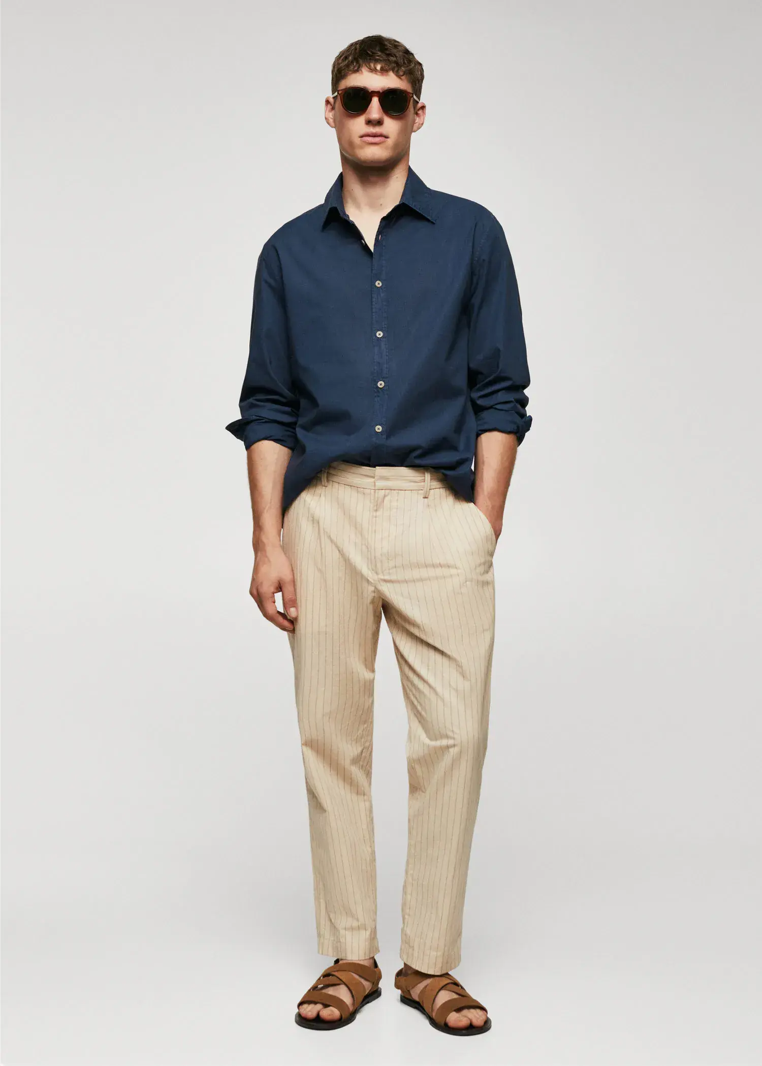 Mango Regular-fit cotton voile shirt. a man in a blue shirt and beige pants. 