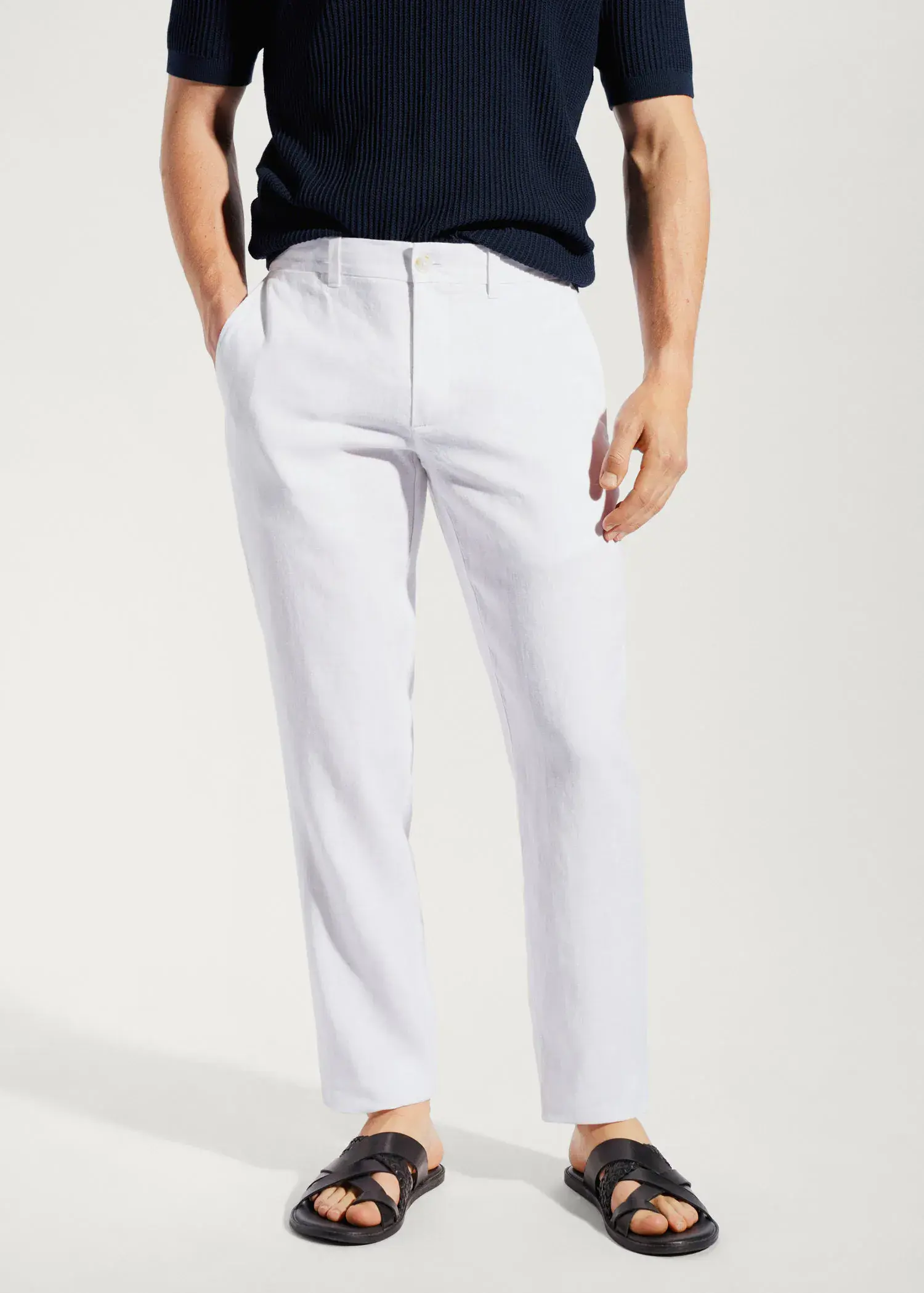 Mango Slim-fit 100% linen trousers. a man wearing white pants and a black shirt. 