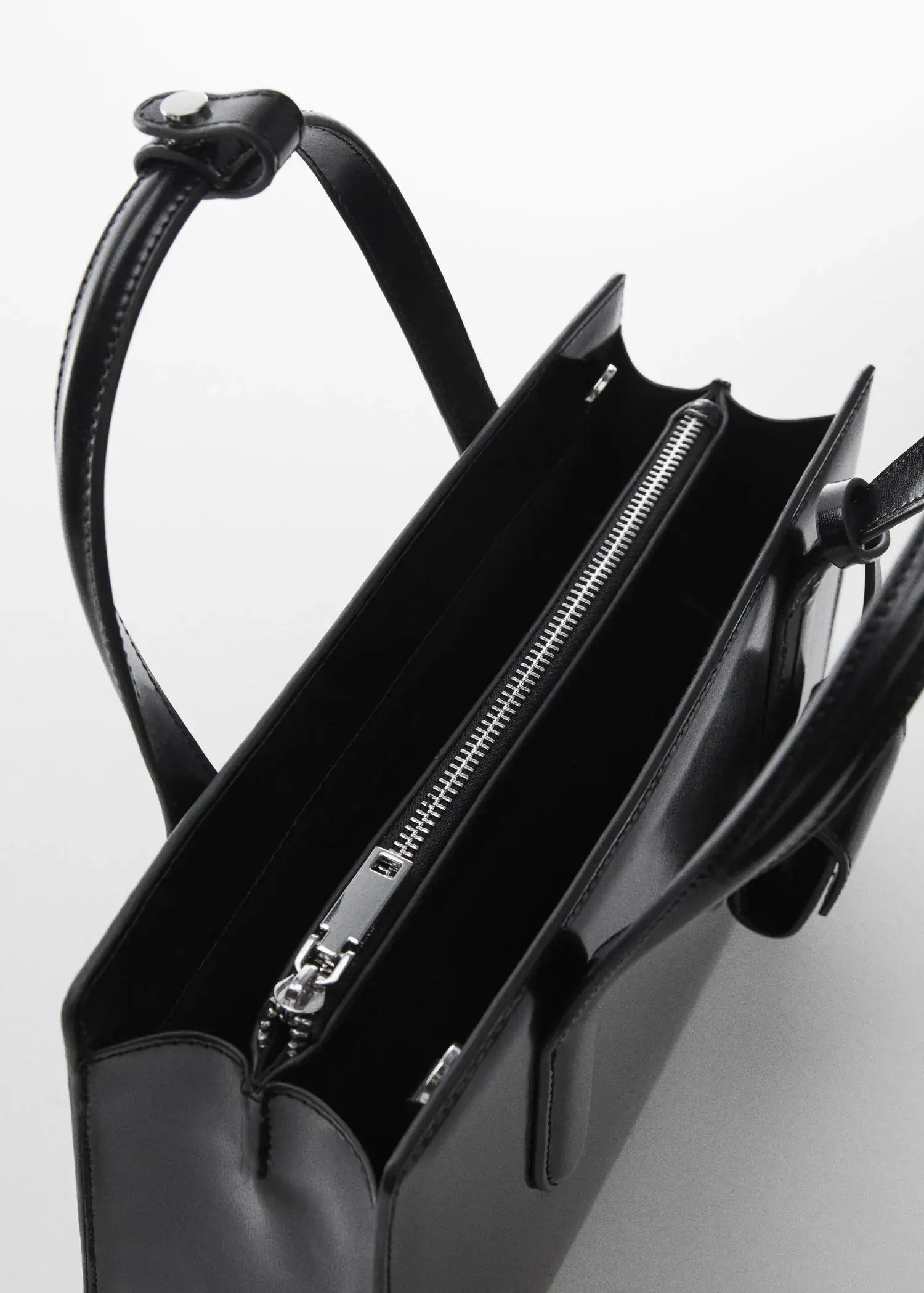 Mango Saffiano-effect shopper bag. a close-up view of the inside of a black purse. 