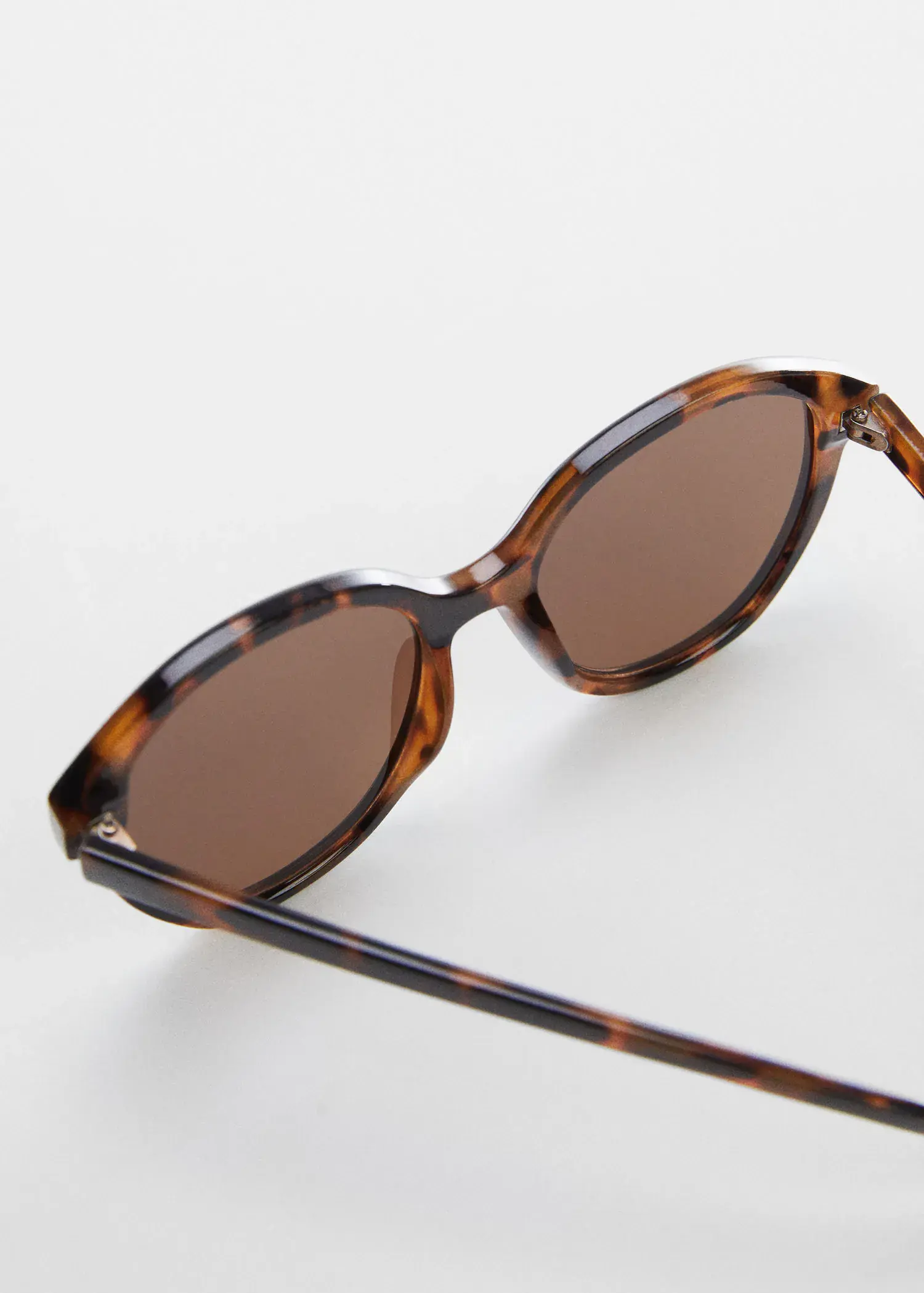 Mango Tortoiseshell rounded sunglasses. a close up of a pair of sunglasses. 