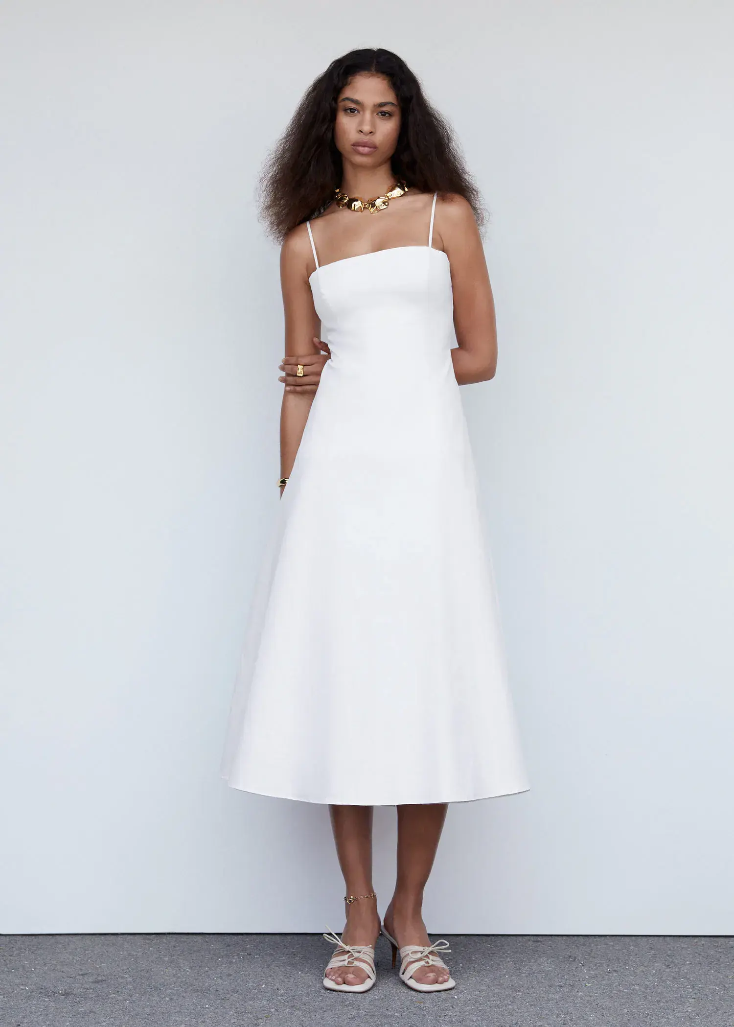 Mango Midi-dress with back detail. a woman in a white dress standing in front of a white wall. 