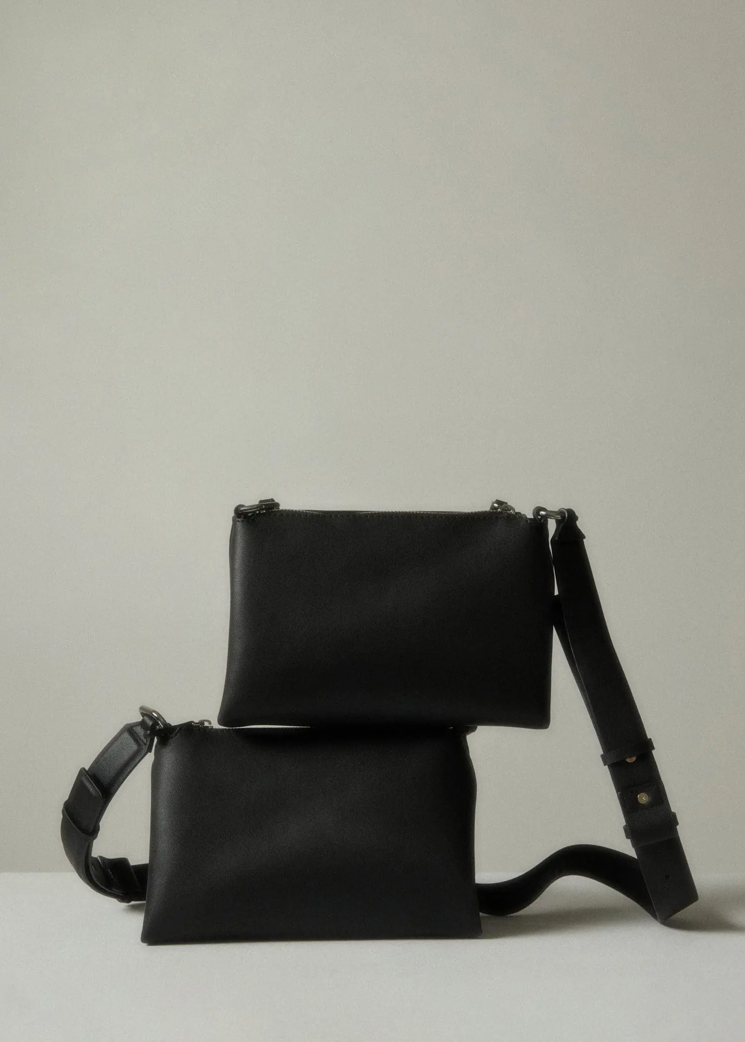 Mango Leather-effect shoulder bag. two black bags are stacked on top of each other. 