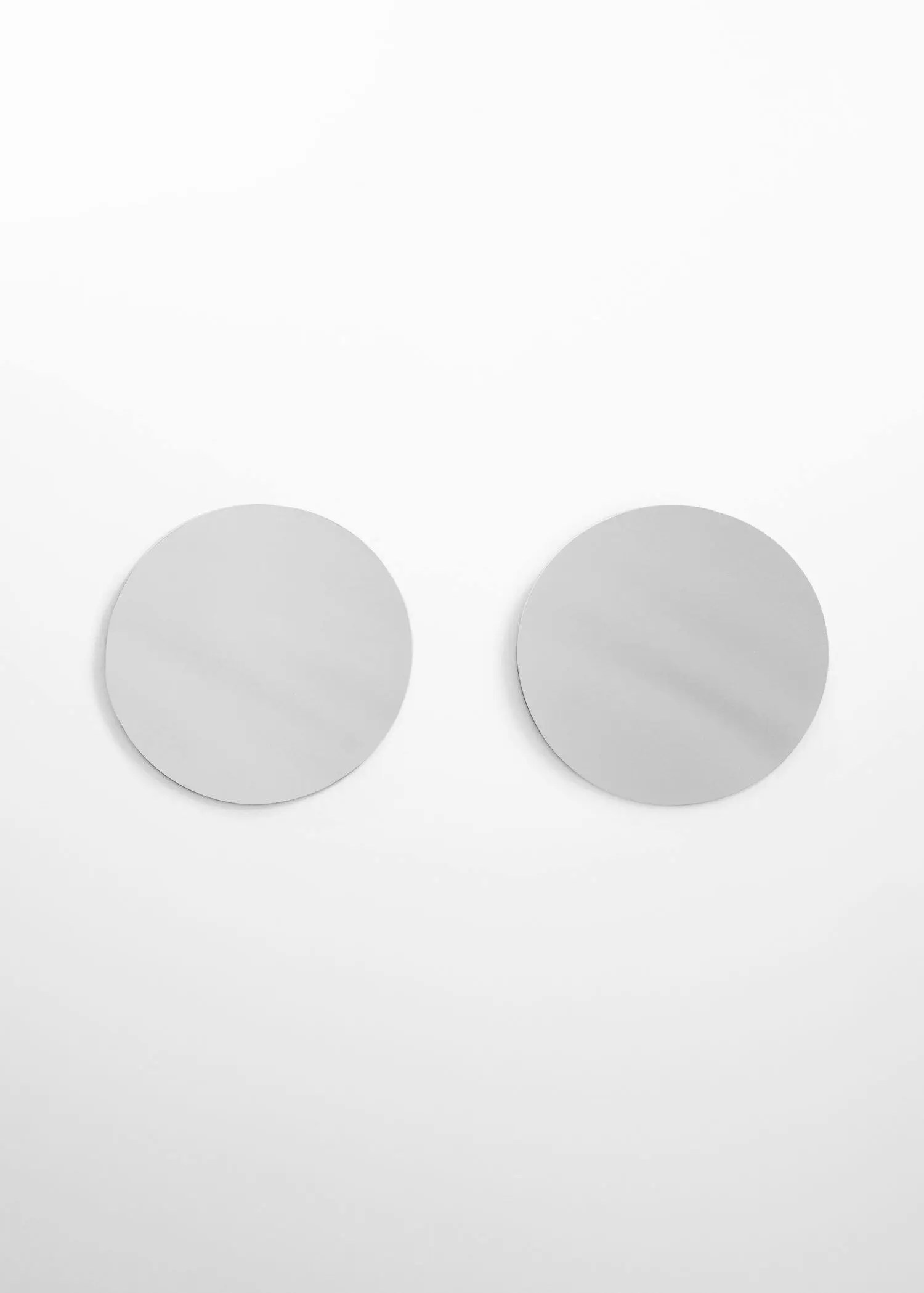 Mango Circle design maxi earrings. a pair of mirrors on a wall. 