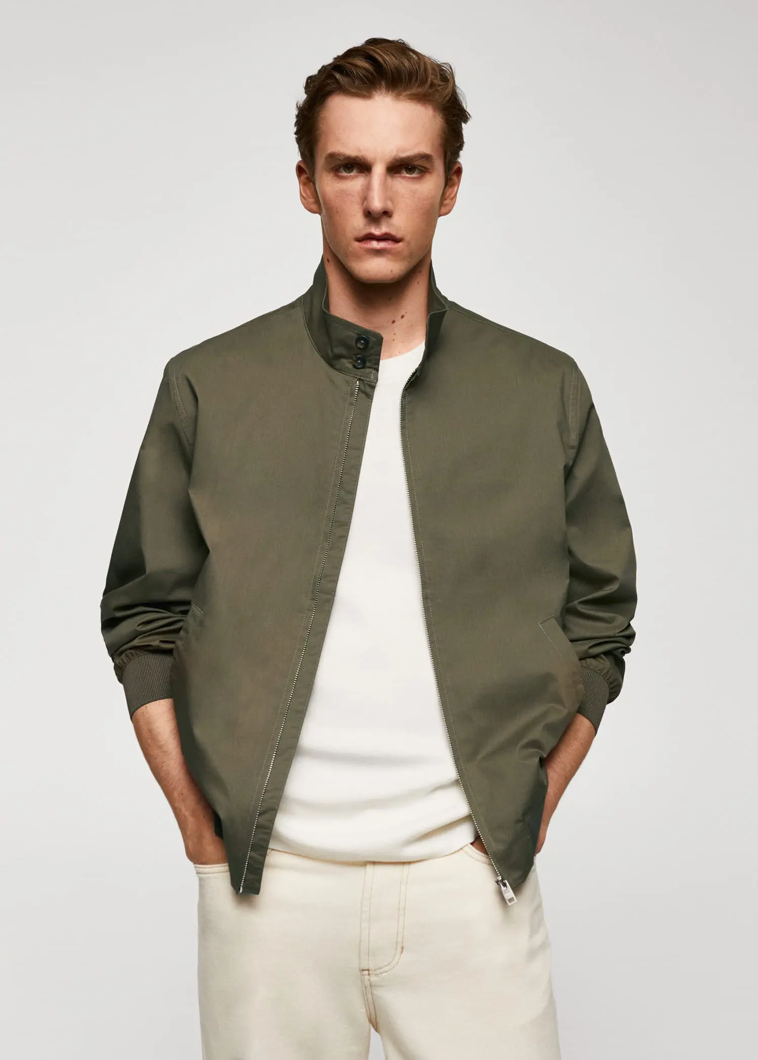 Mango Lightweight fabric bomber jacket. a man wearing a green jacket and a white shirt. 