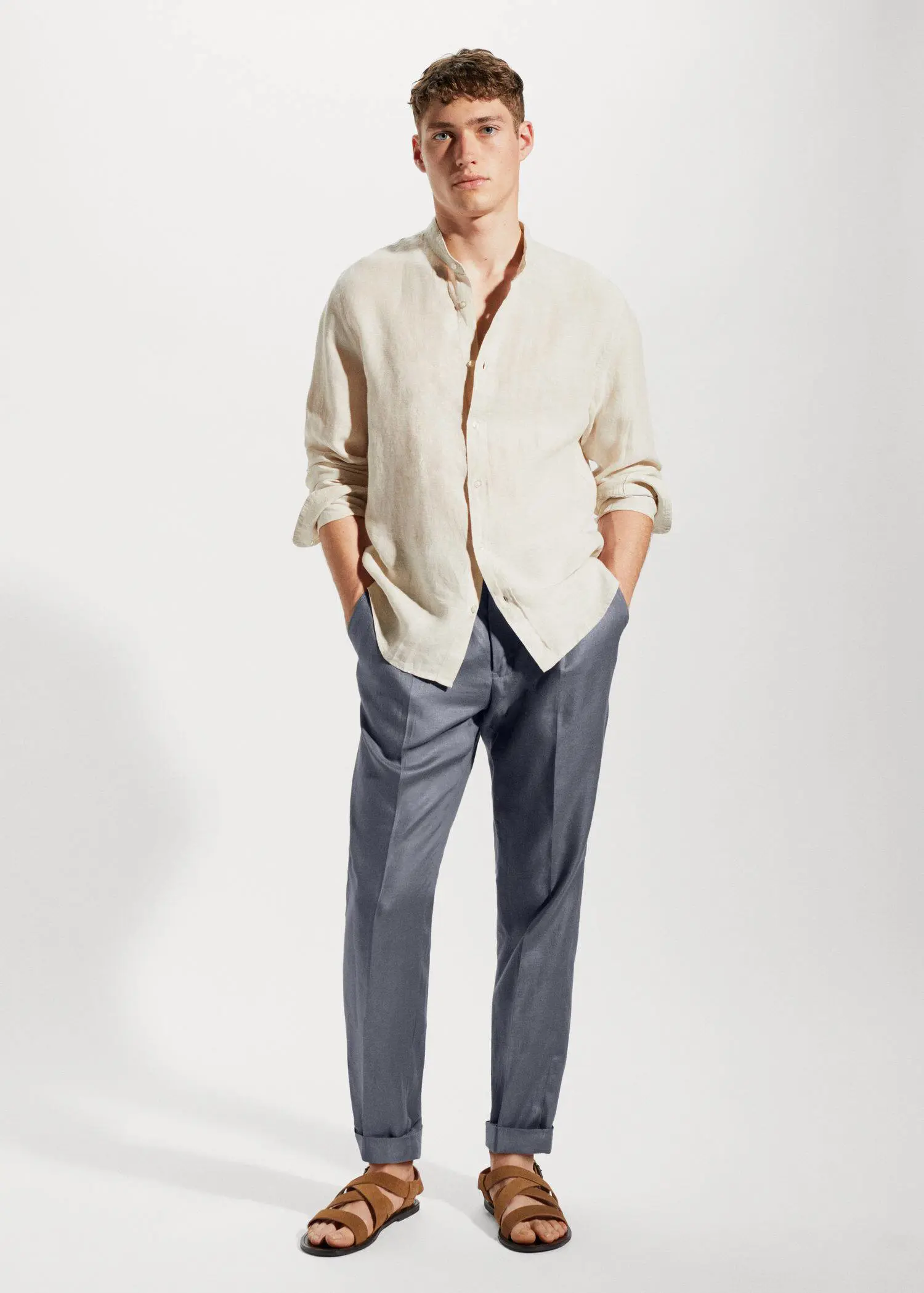 Mango 100% linen Mao collar shirt. a man wearing a white shirt and blue pants. 