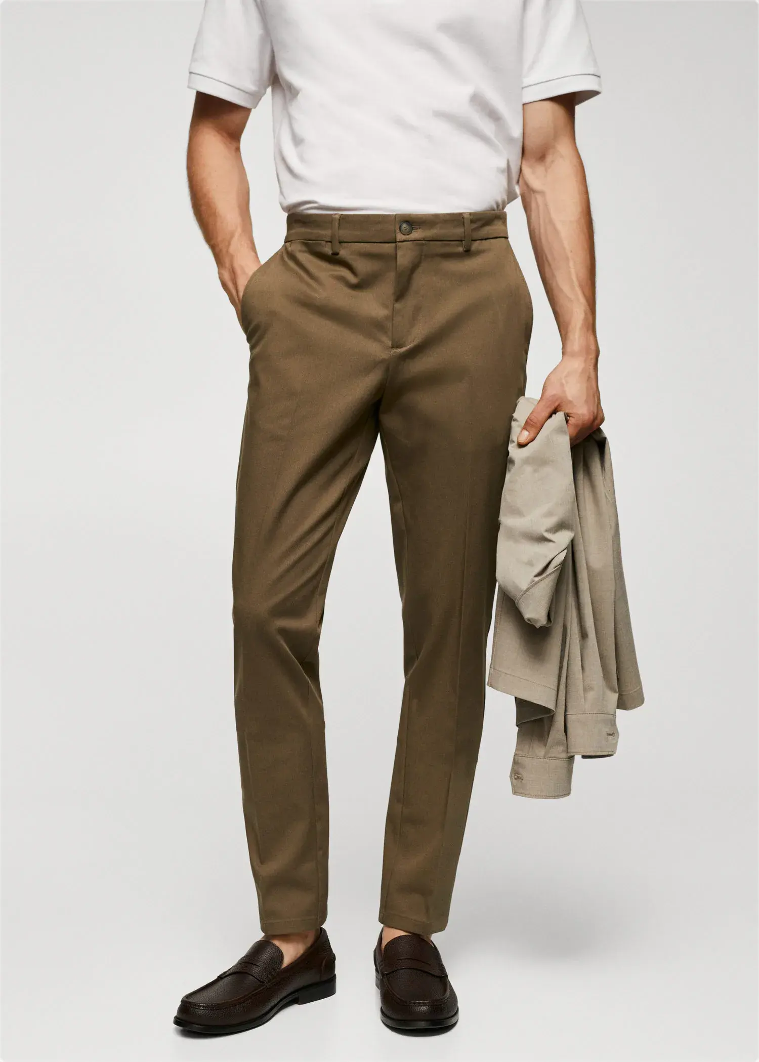 Mango Slim fit chino trousers. a man wearing a white shirt and brown pants. 