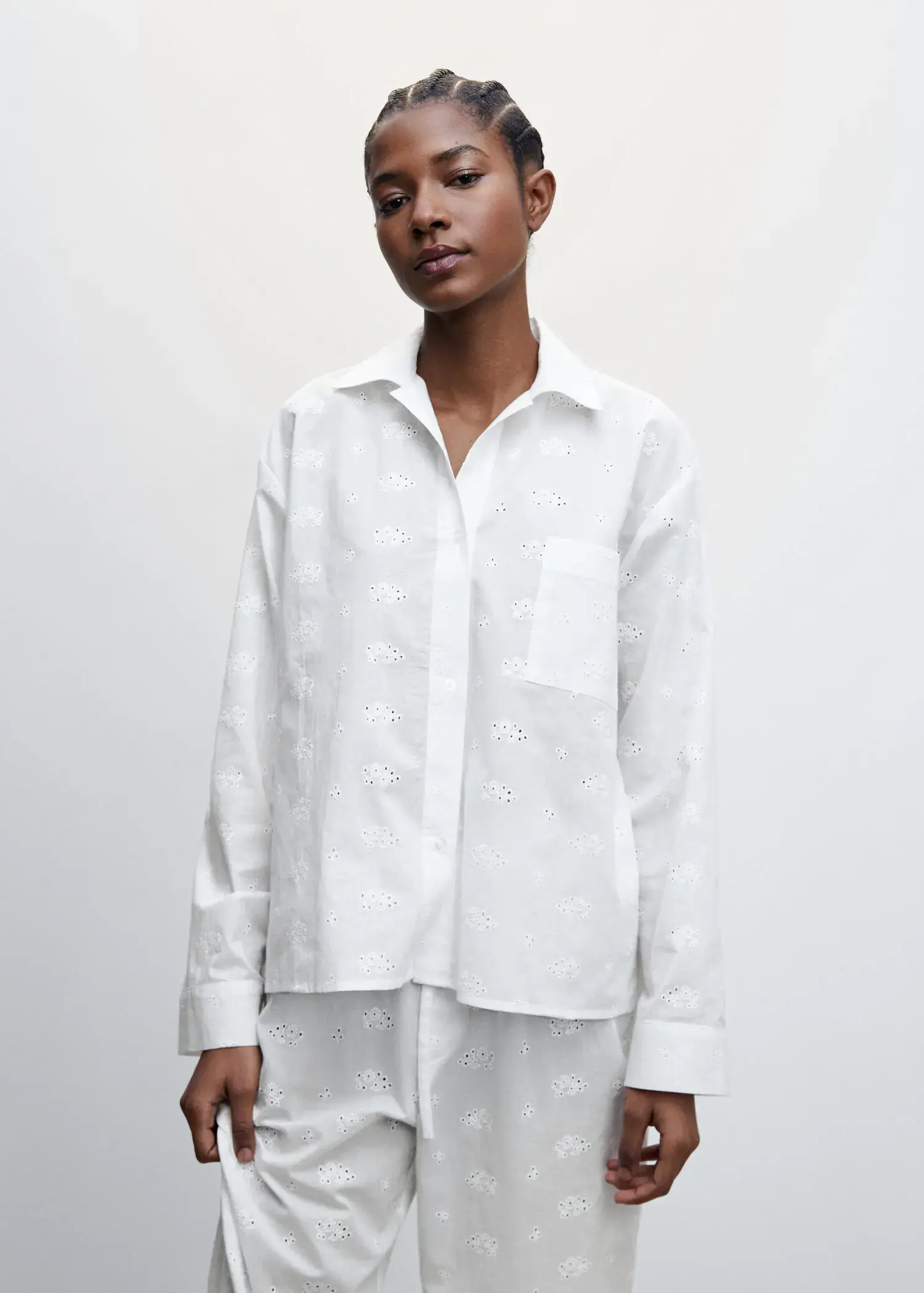 Mango Pyjama shirt with openwork details. a woman wearing a white shirt and white pants. 