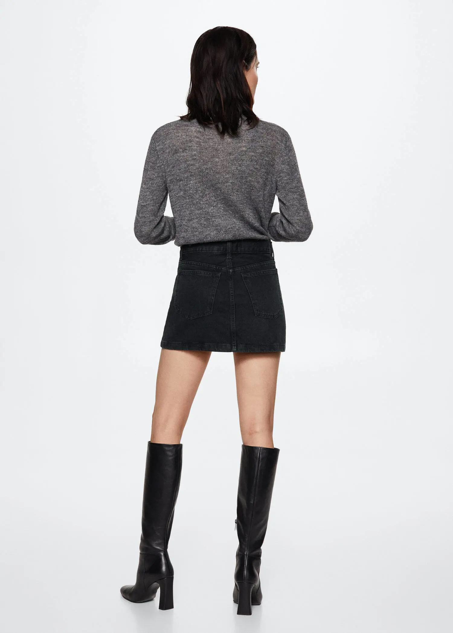 Mango Denim miniskirt. a woman in black skirt and black boots. 