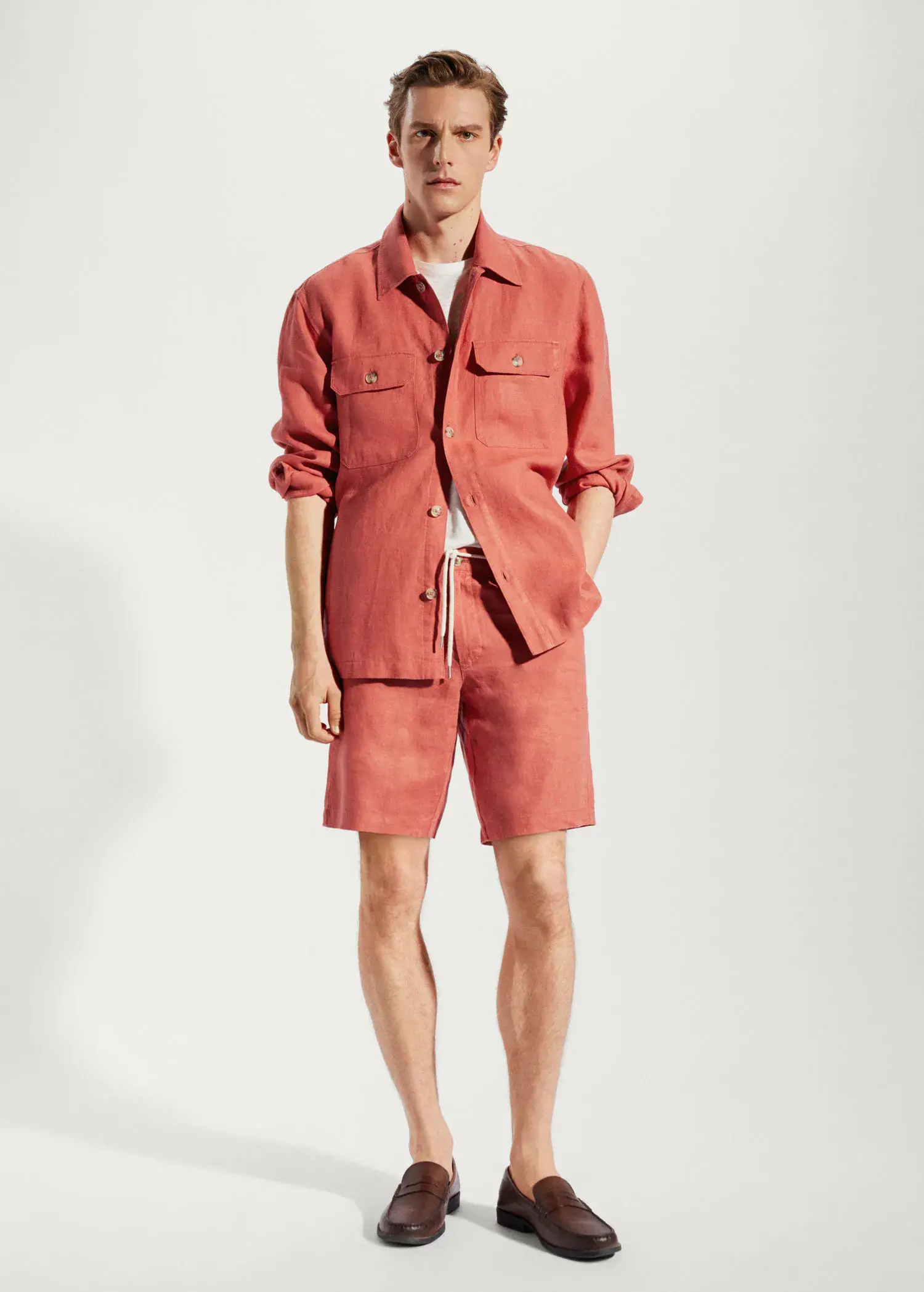 Mango 100% linen regular-fit overshirt. a man wearing a red shirt and shorts. 
